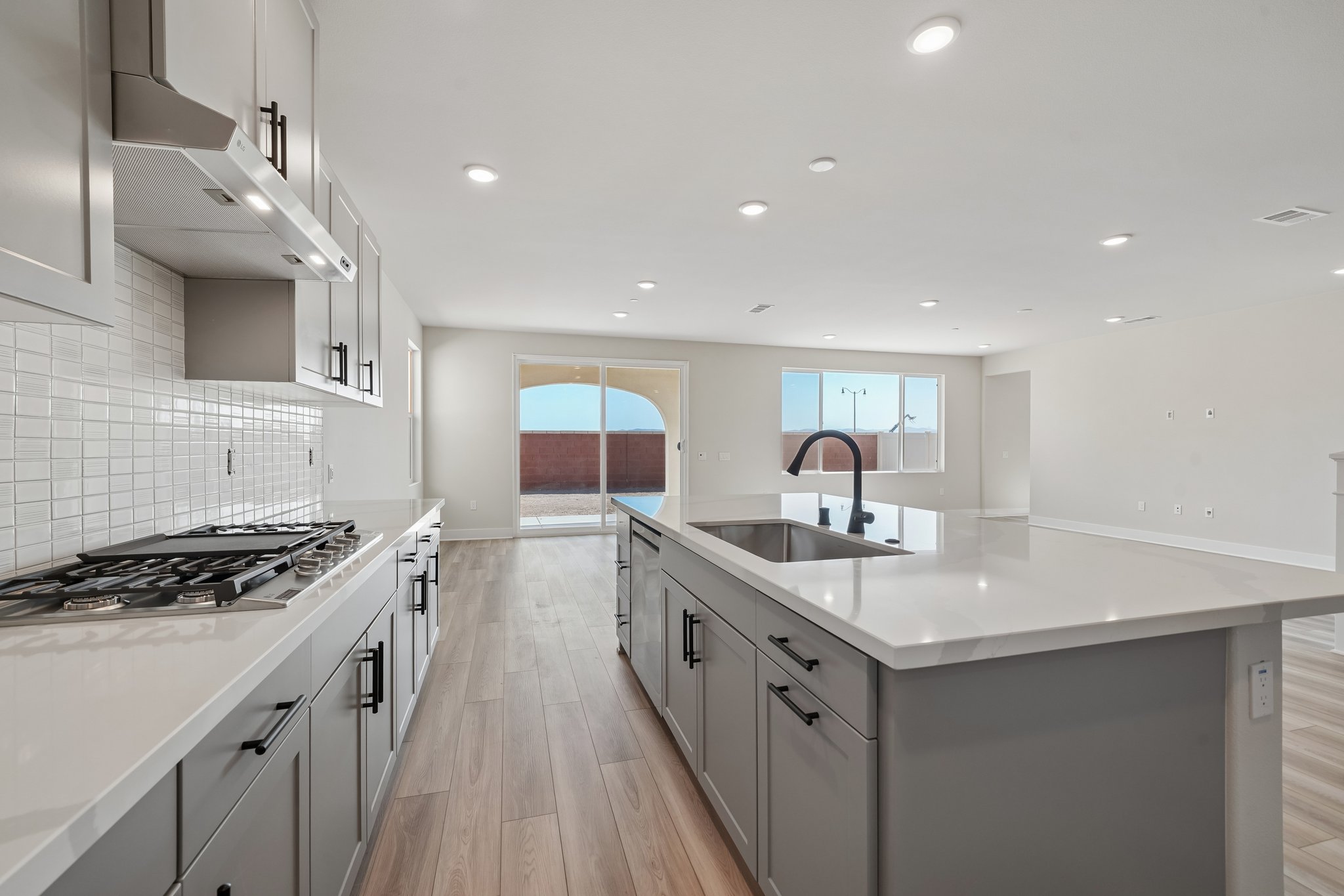 A kitchen with white cabinets.