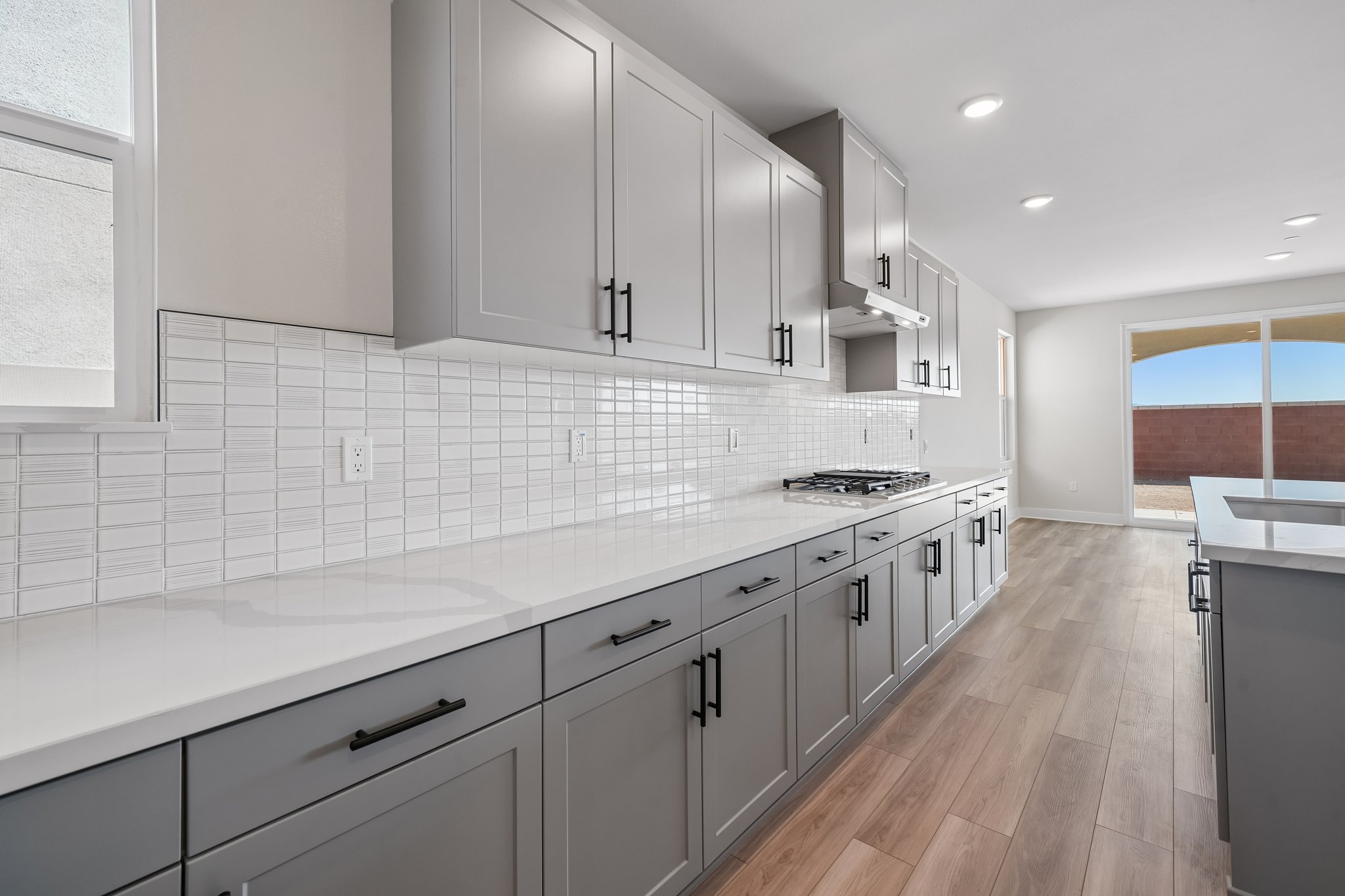 A kitchen with white cabinets.
