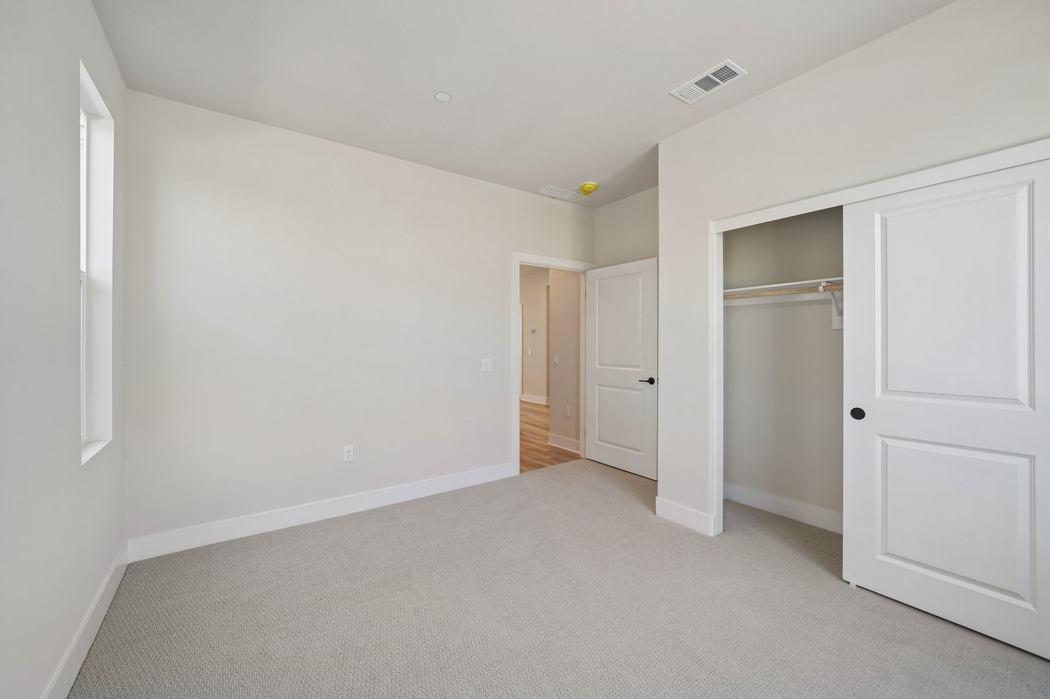 A hallway with white doors.