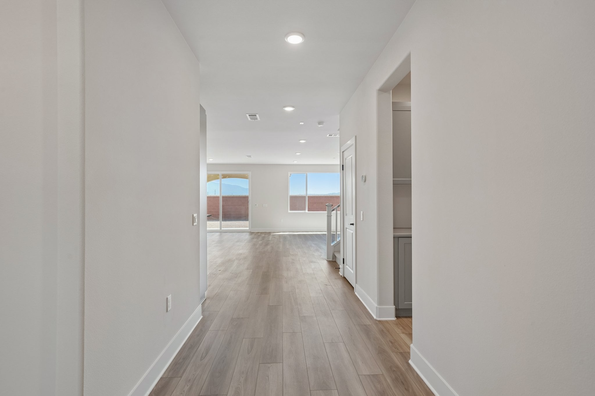 A long hallway with white walls.