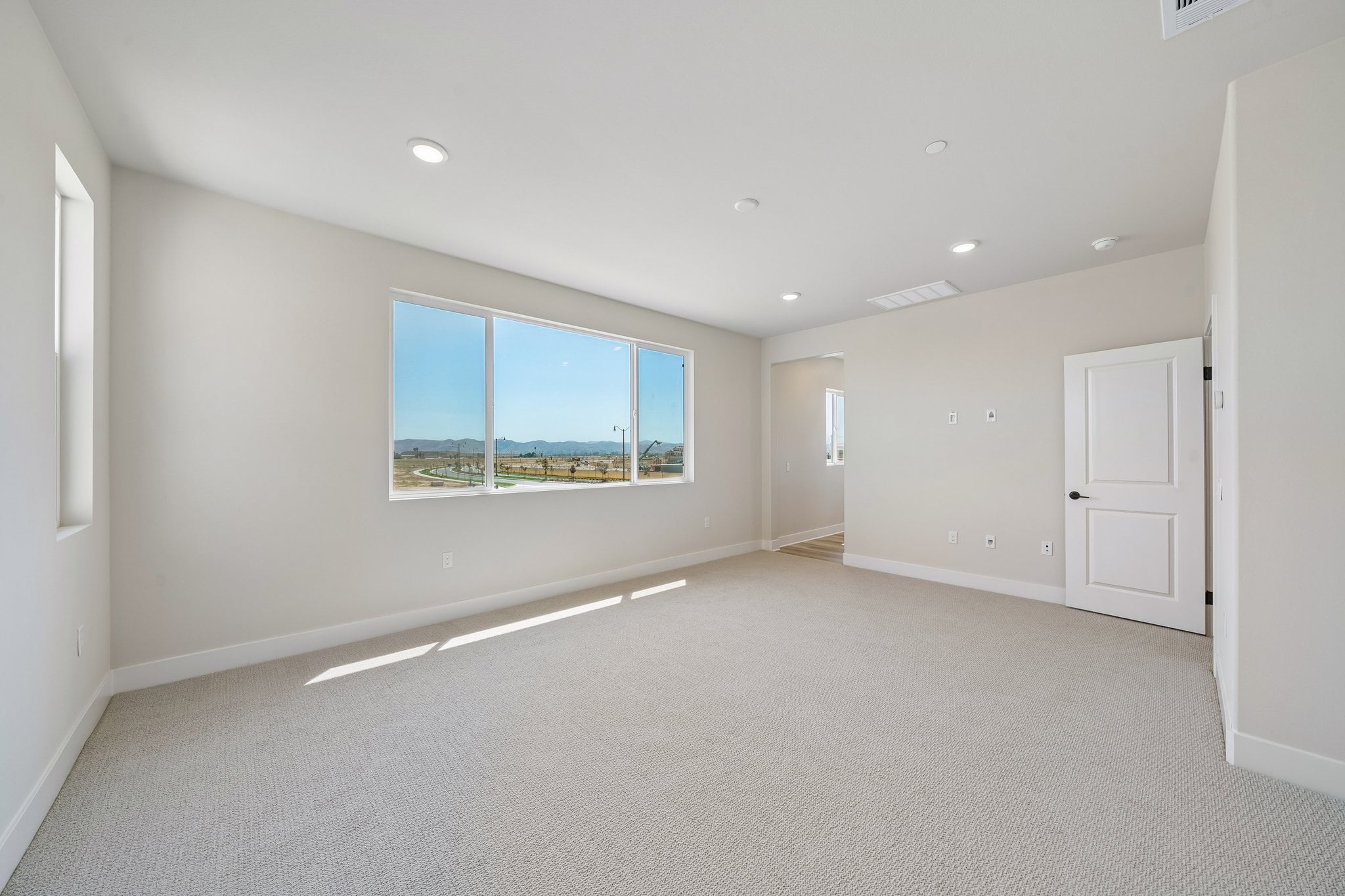 A room with a window and a door.