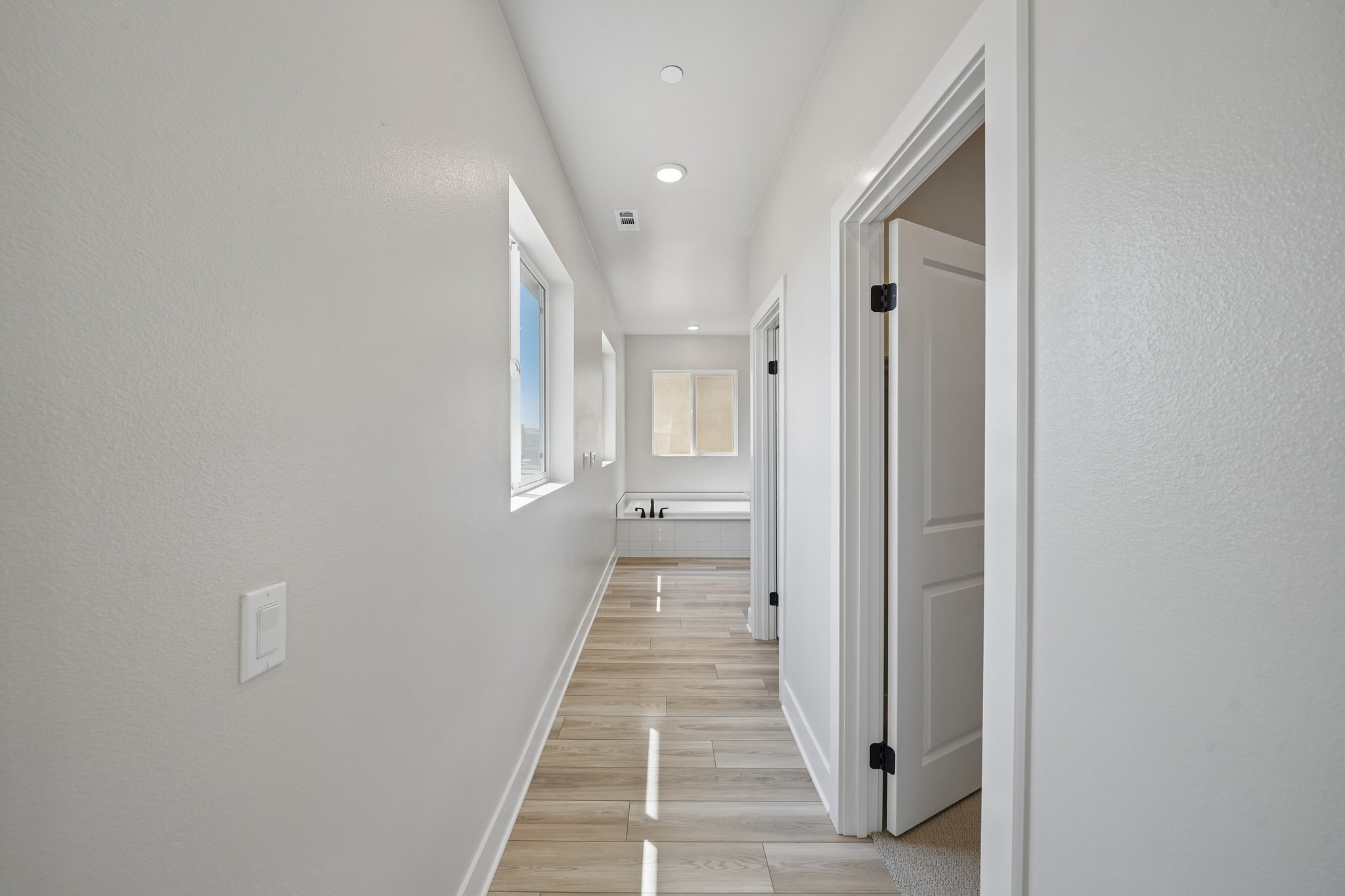 A hallway with white walls.