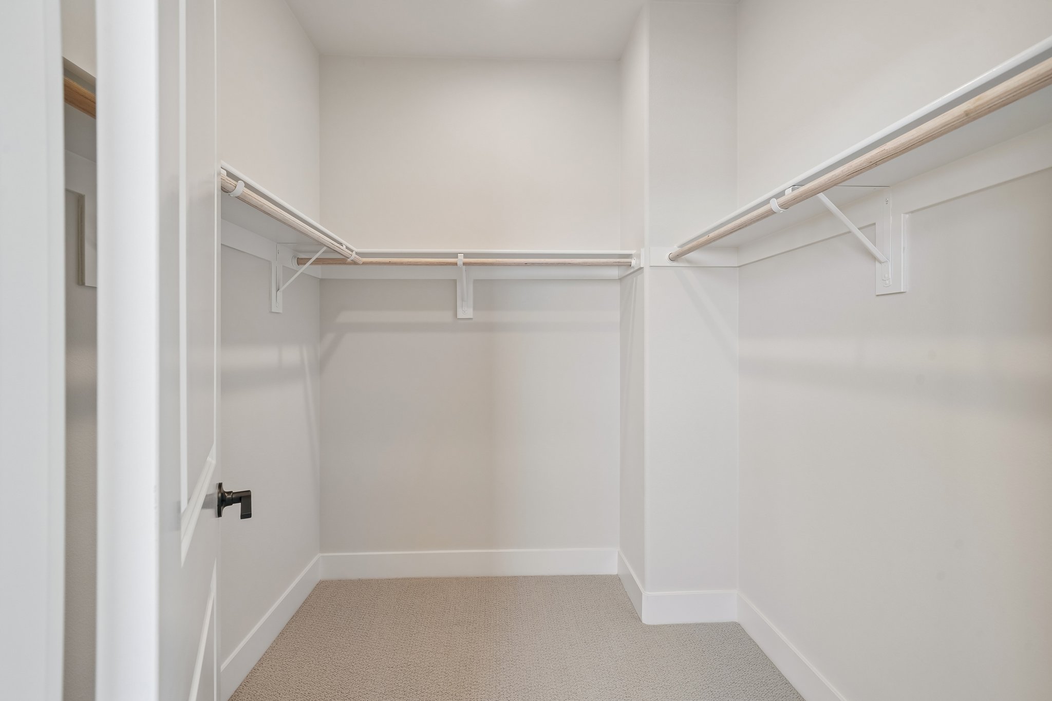 A white room with a metal railing.