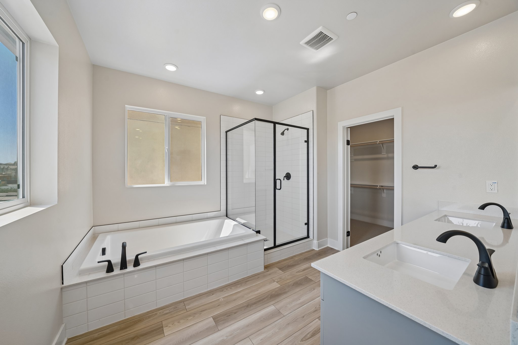 A bathroom with a tub sink and a shower.