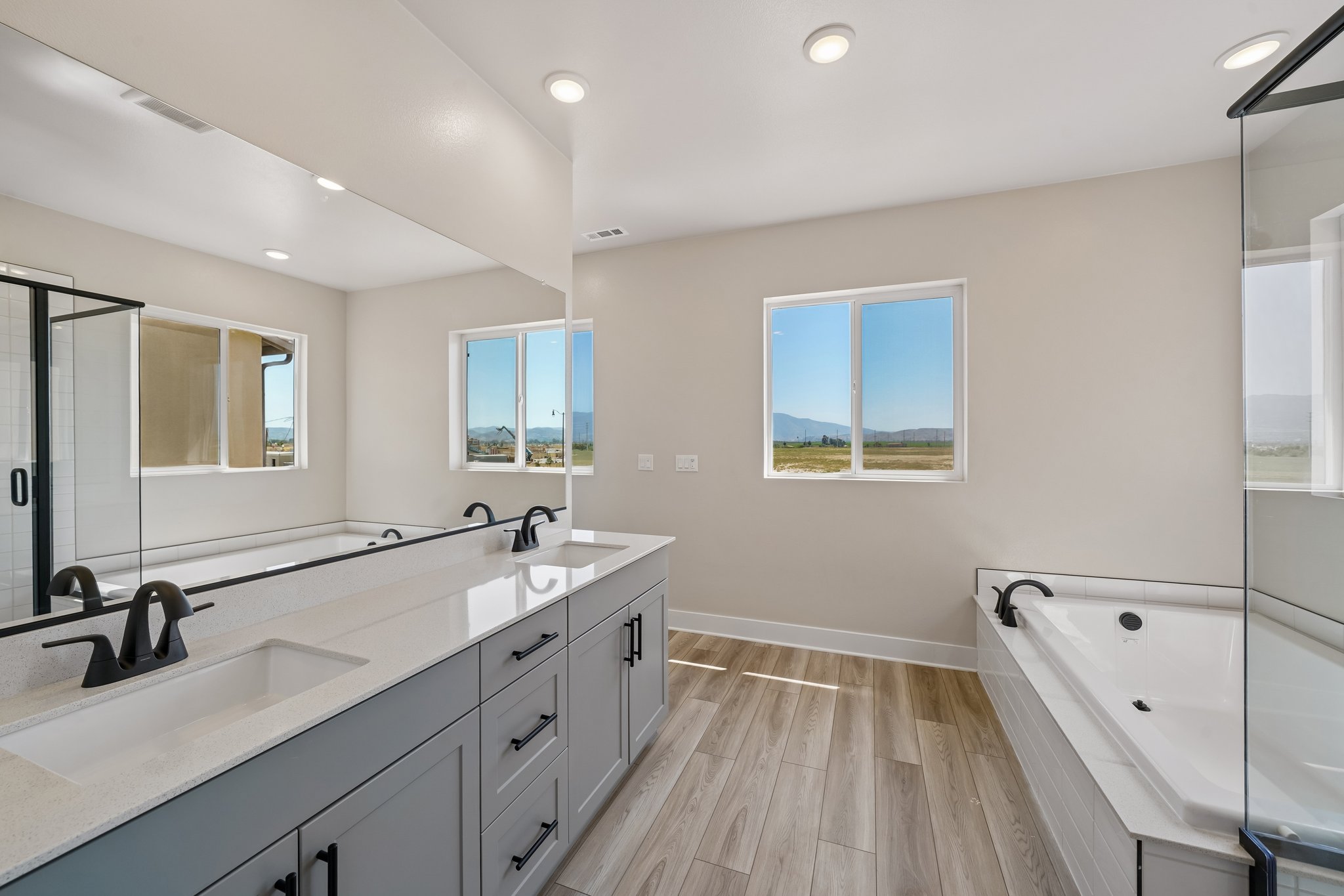 A bathroom with a large mirror.