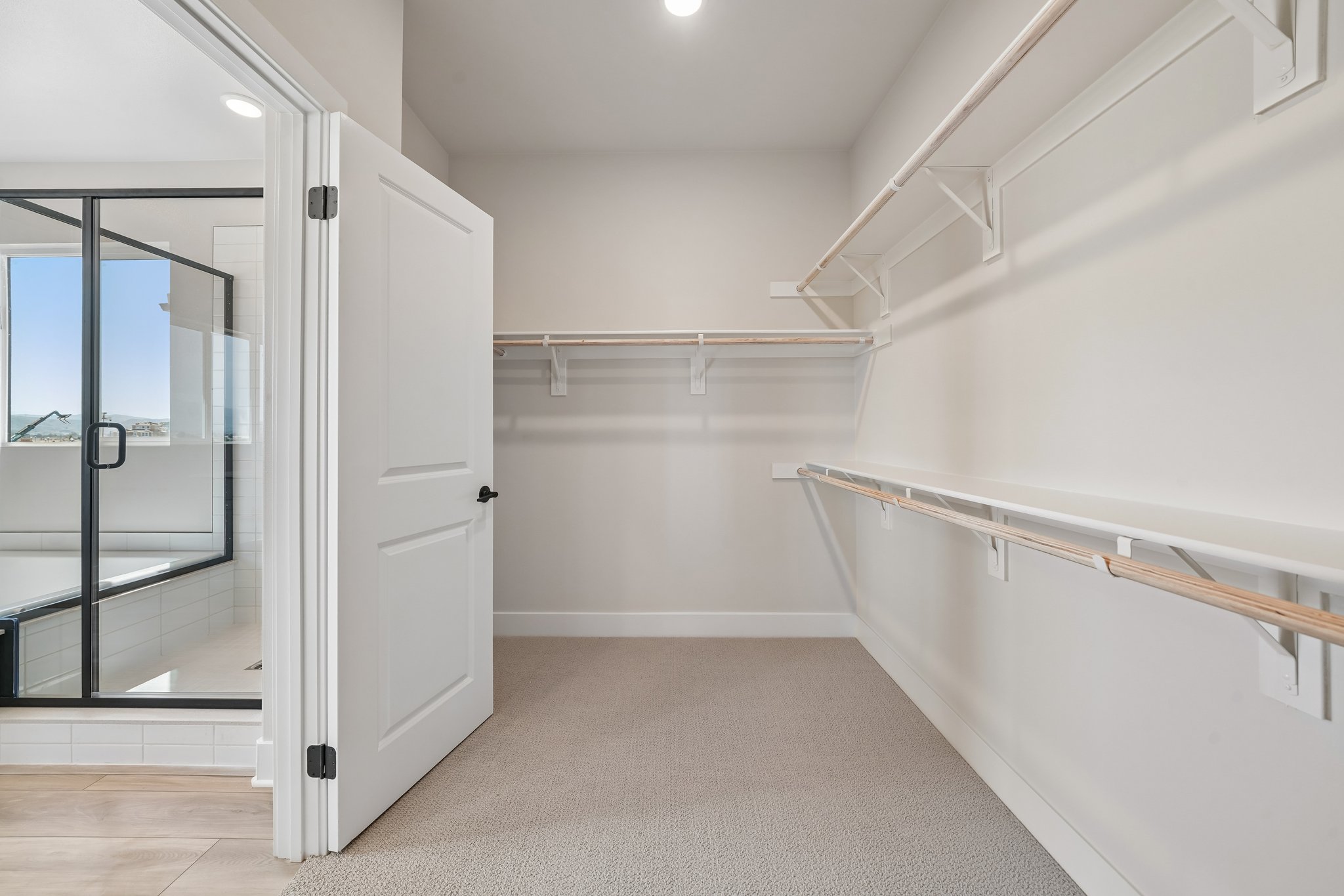 A white room with a glass door.