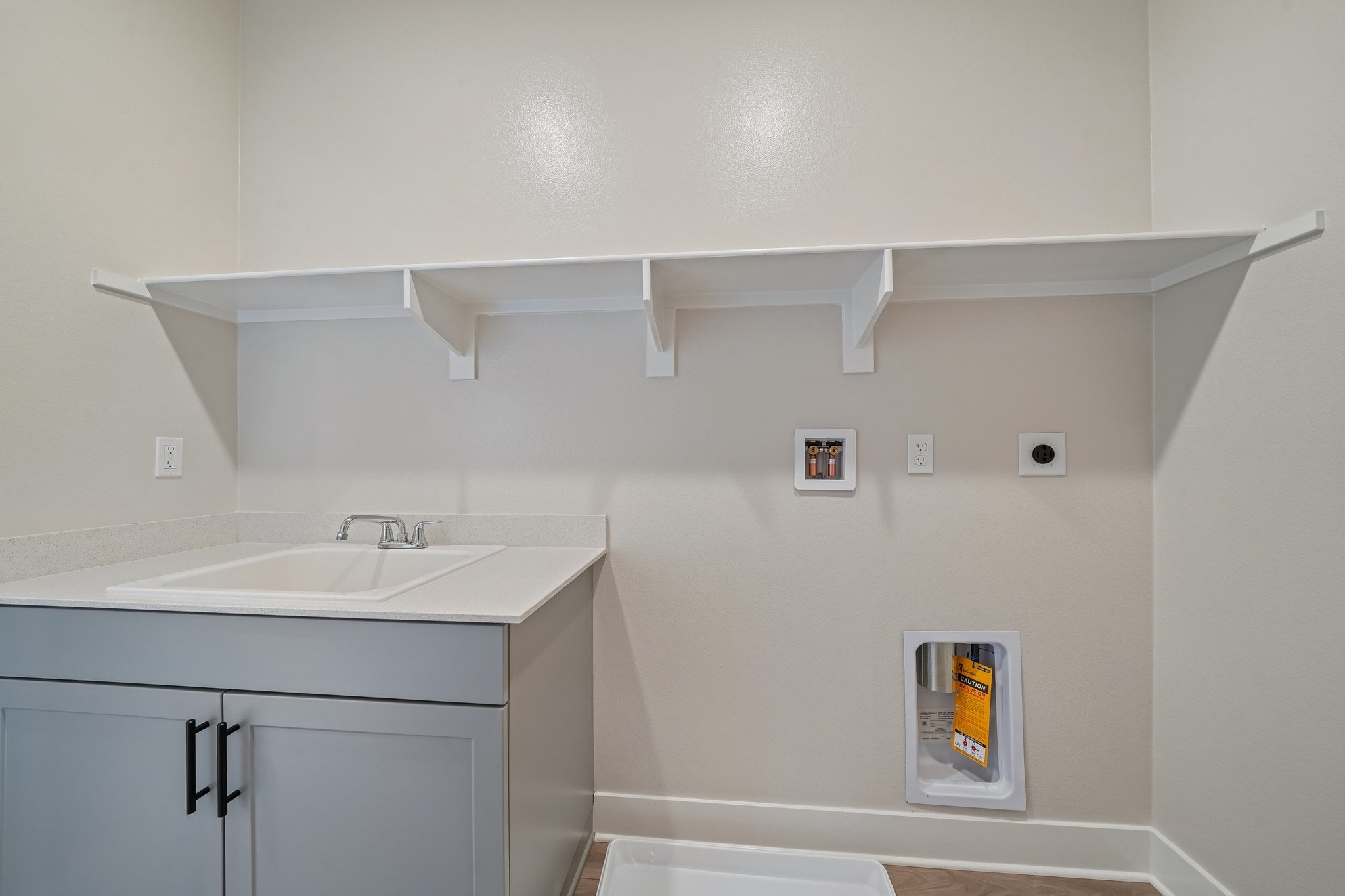 A white kitchen with a white shelf.