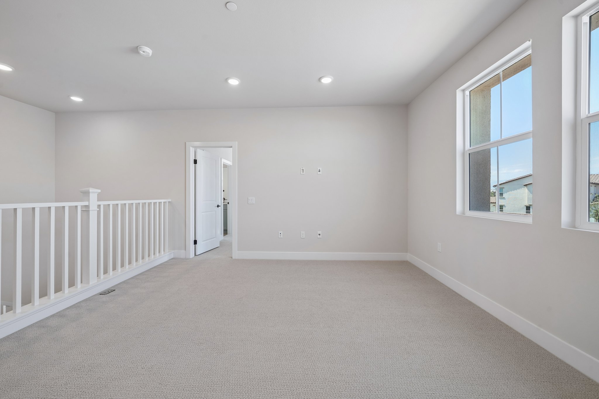 A room with a white railing and a white railing.