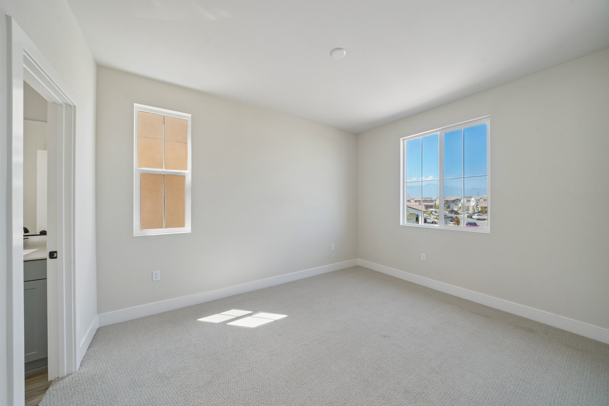 A room with a window and a door.