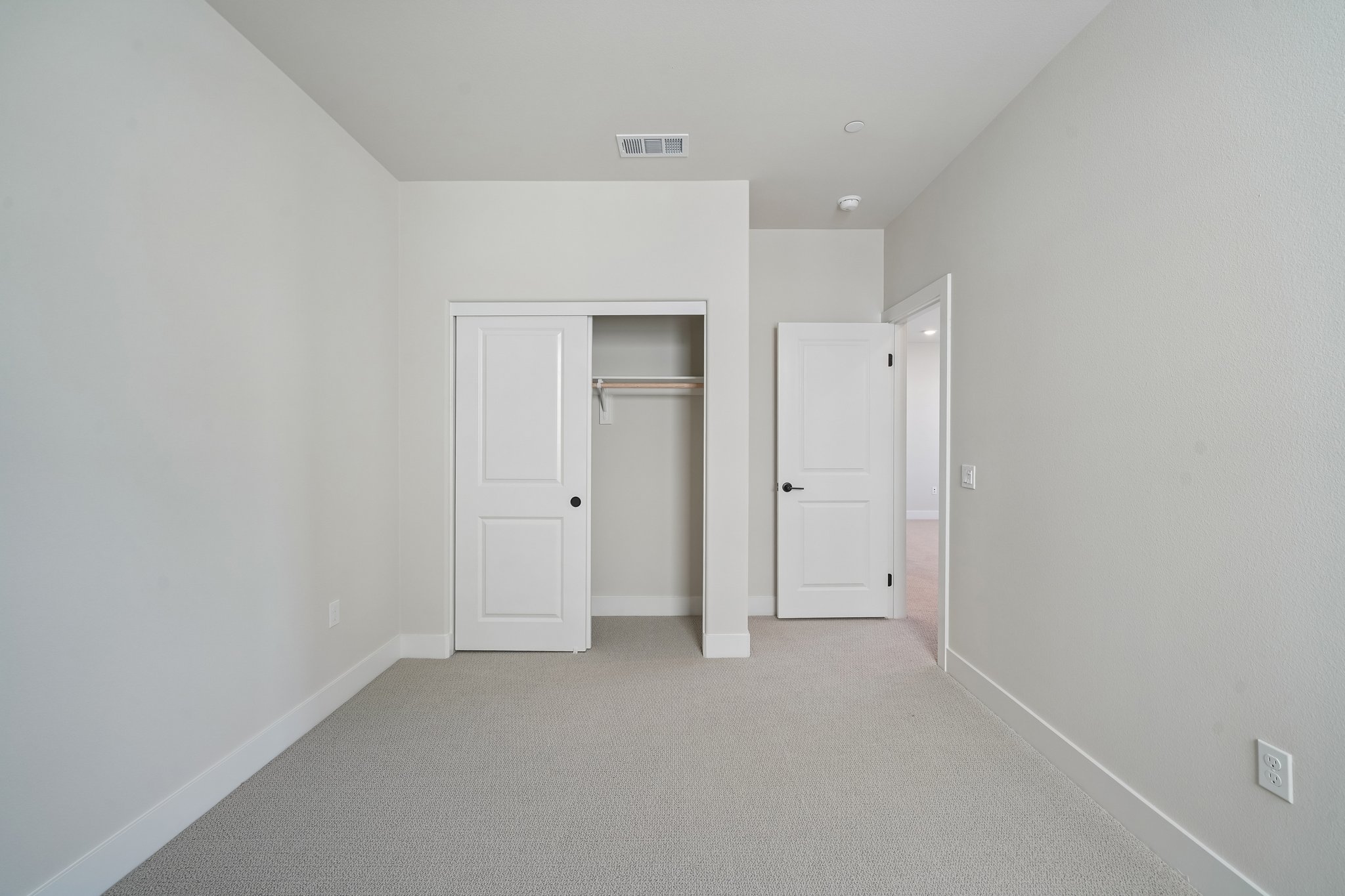 A hallway with white doors.