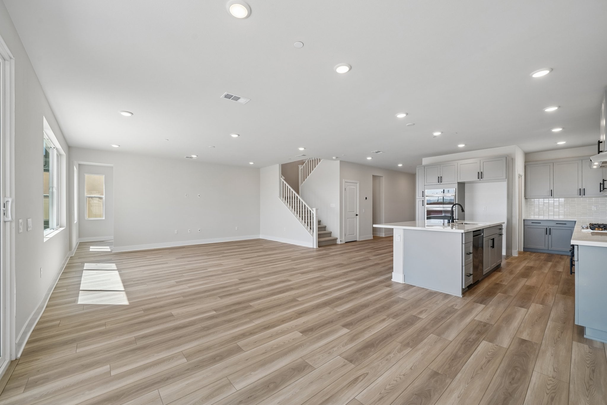 A large kitchen with wood floors.