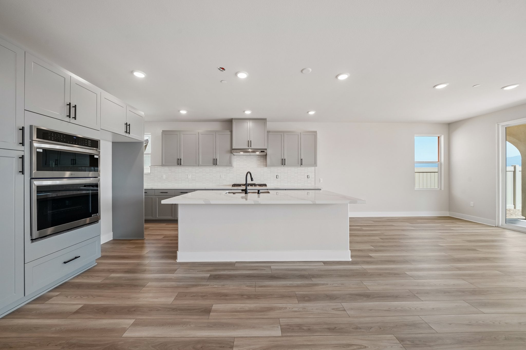A kitchen with white cabinets.