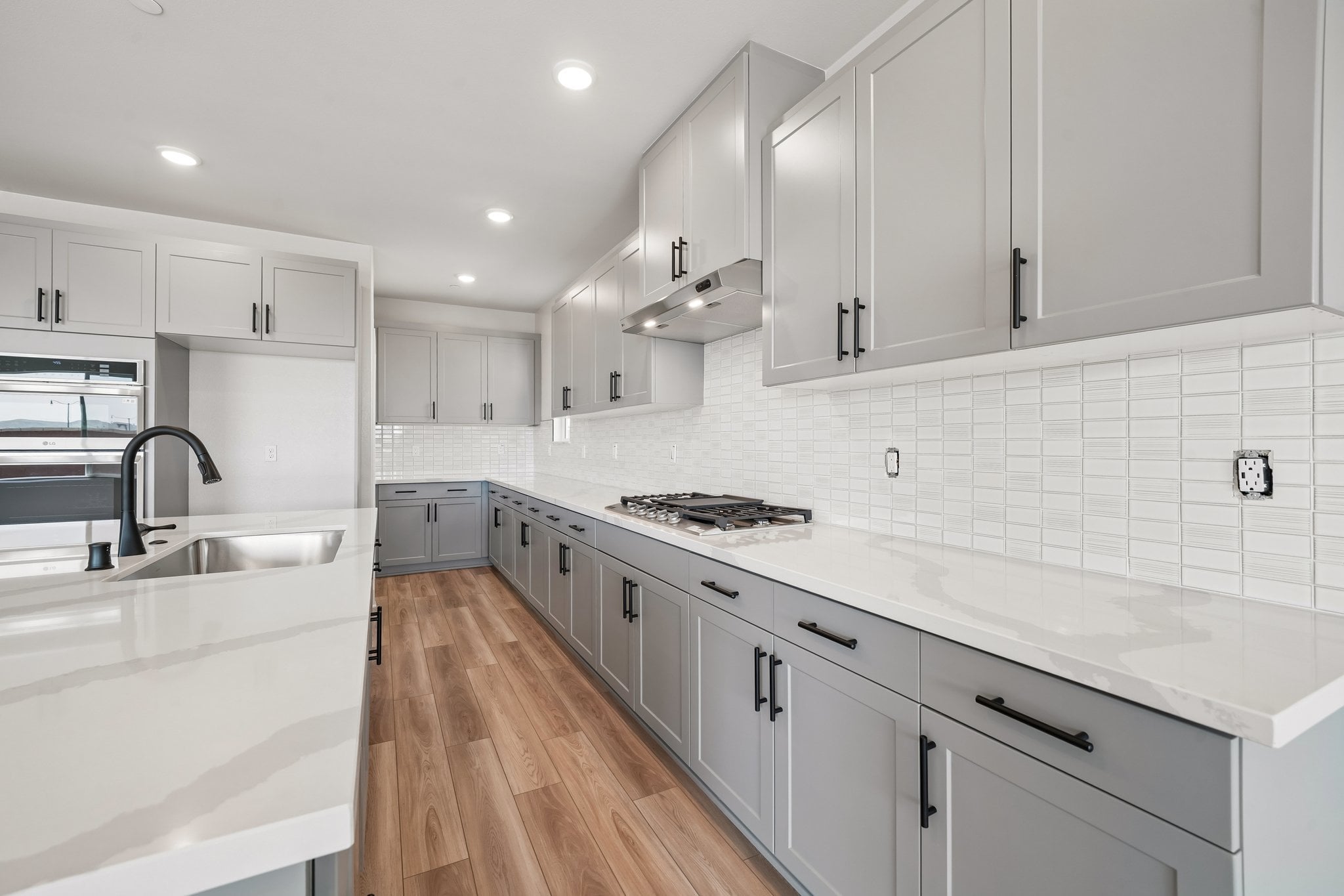 A kitchen with white cabinets.