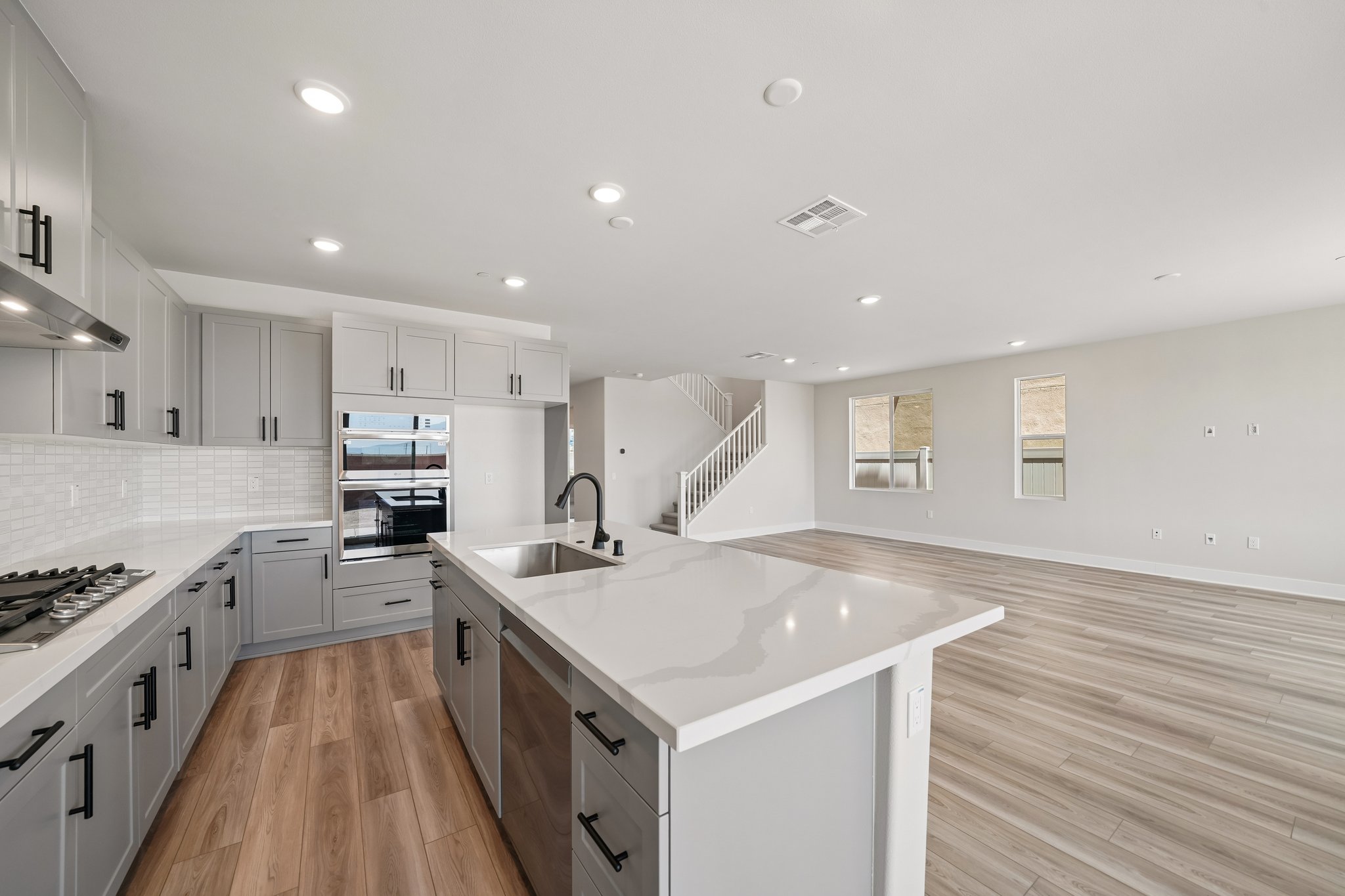 A kitchen with white cabinets.