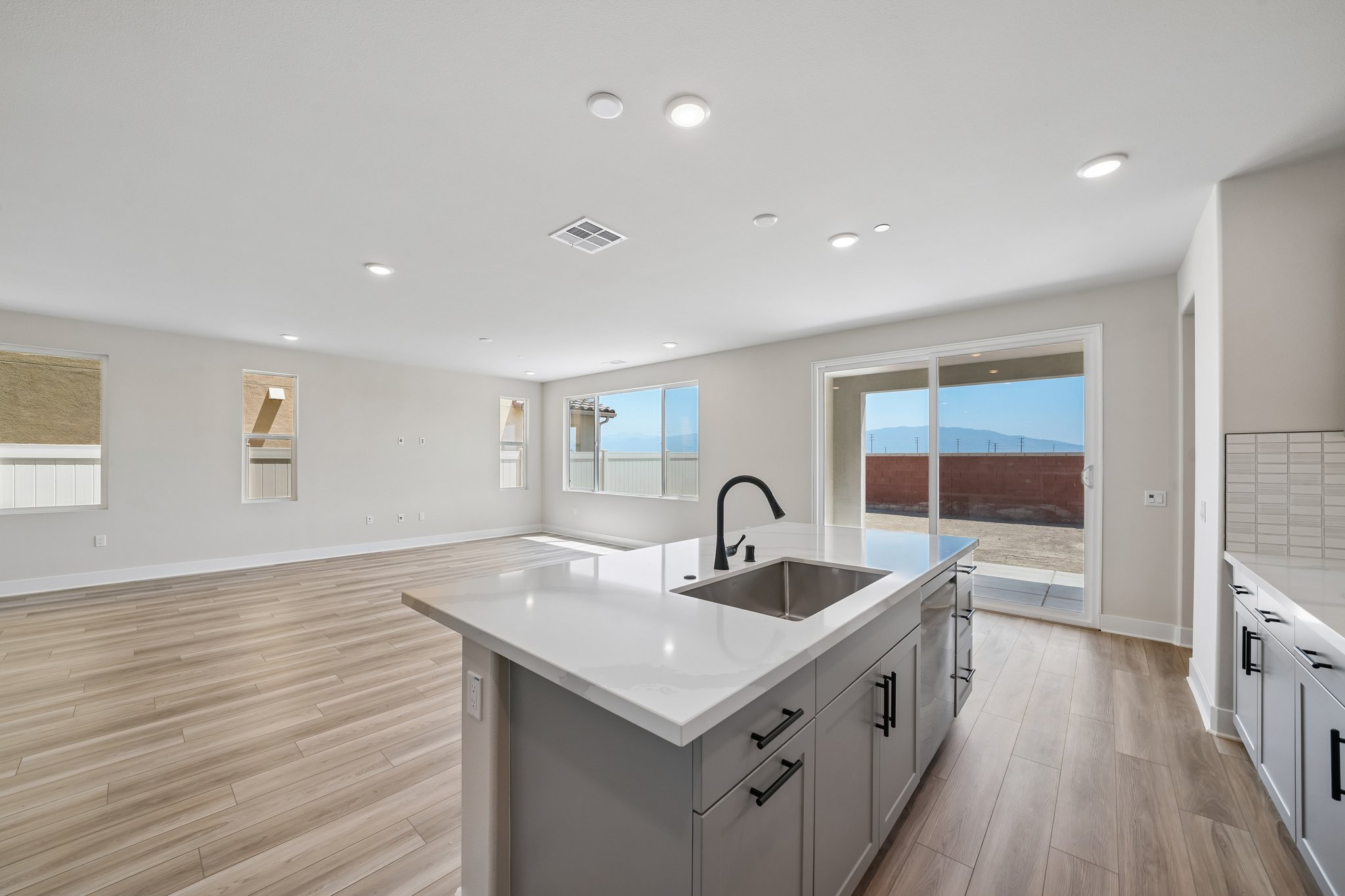 A kitchen with a large window.