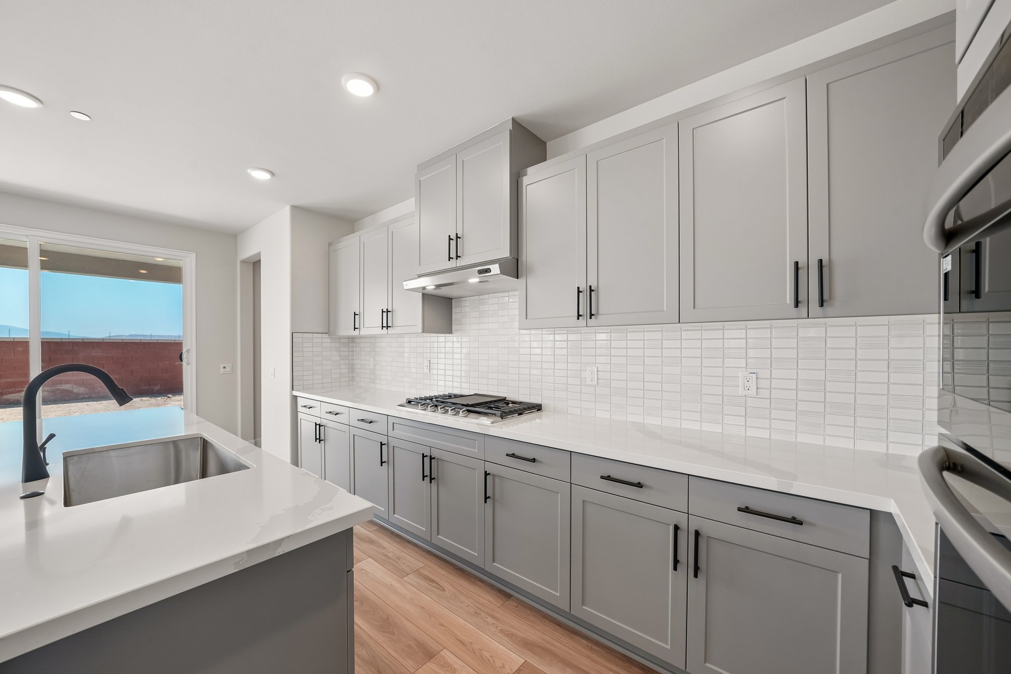 A kitchen with white cabinets.
