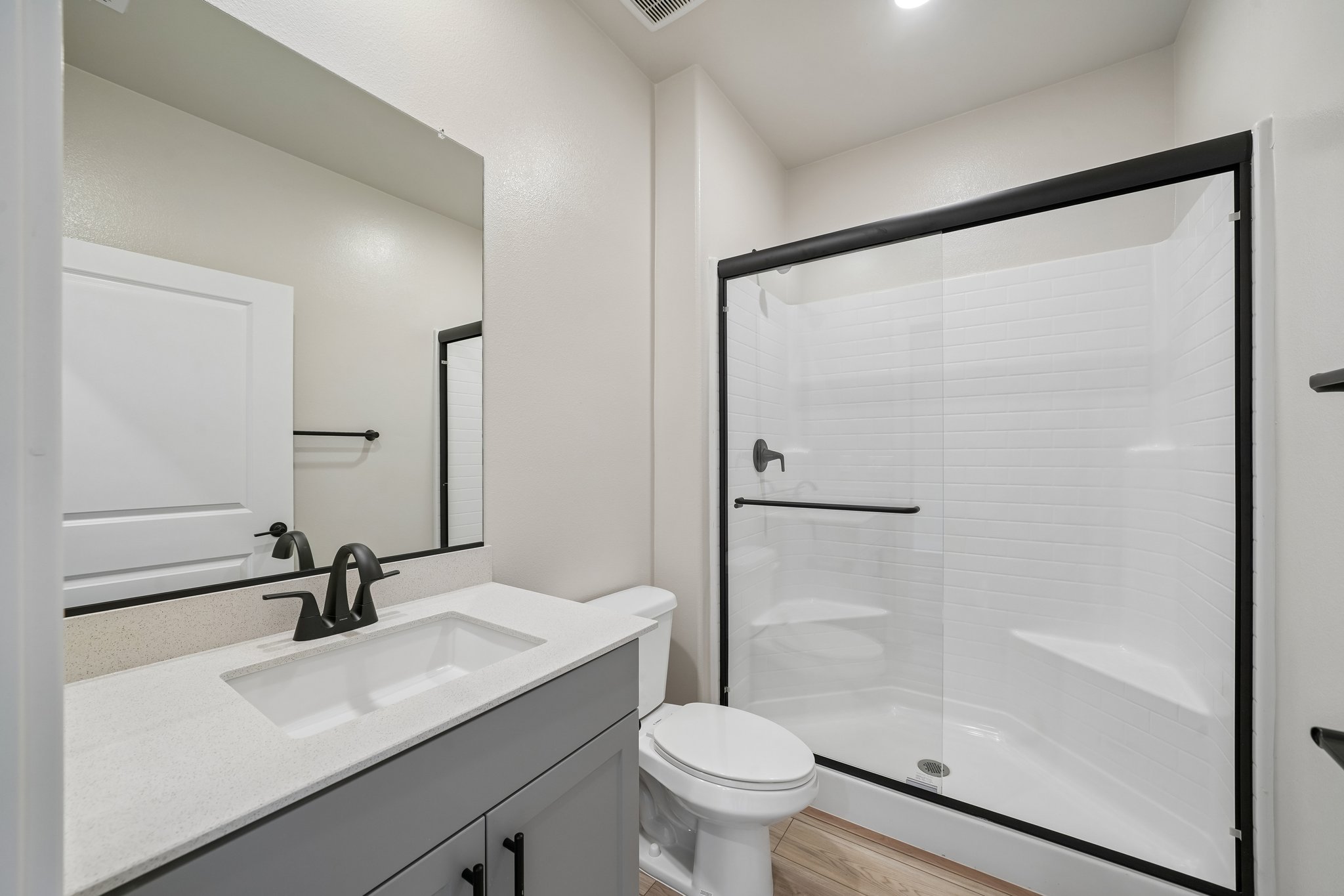 A bathroom with a shower and sink.