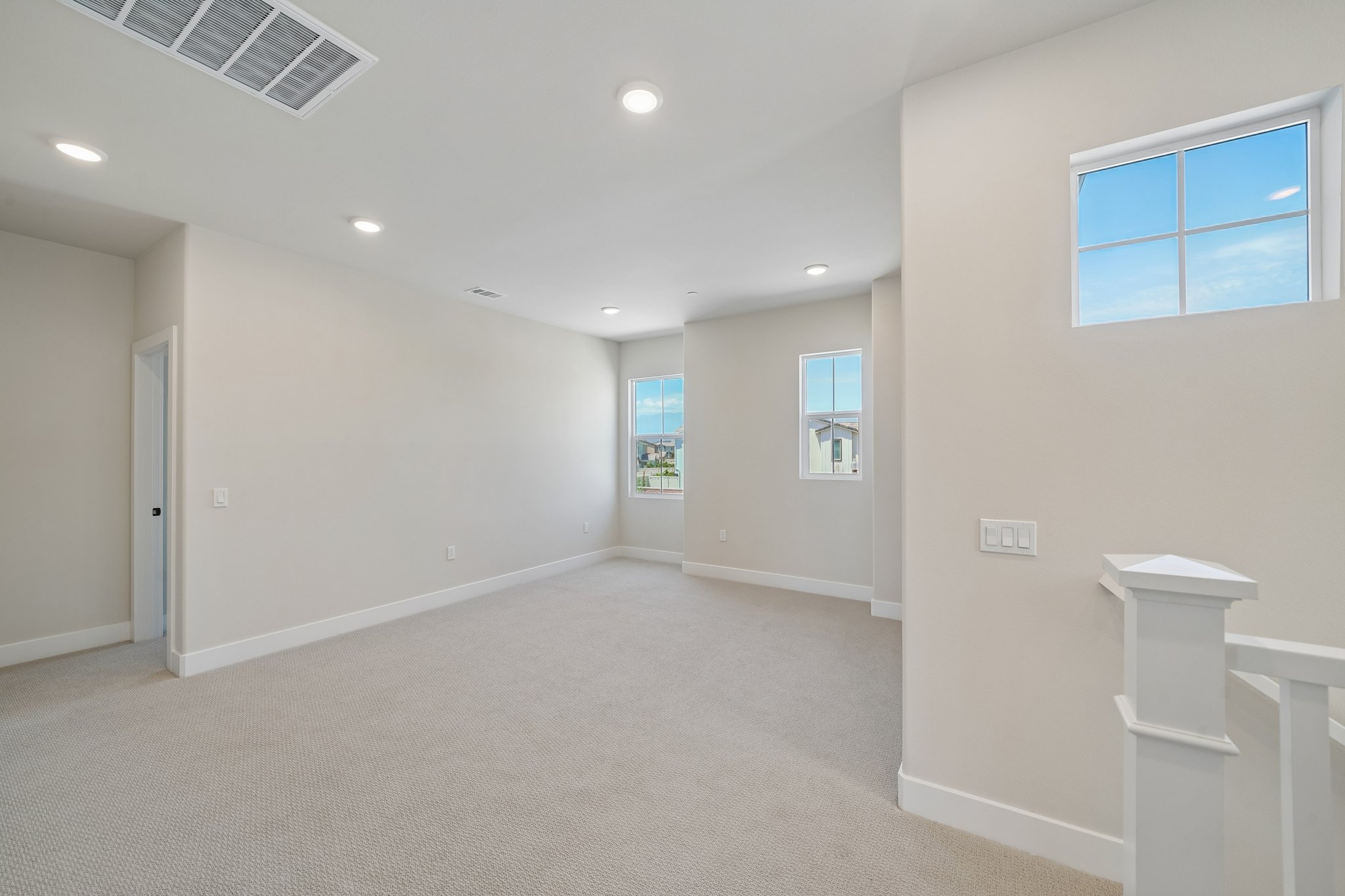 A room with a white wall and a window.