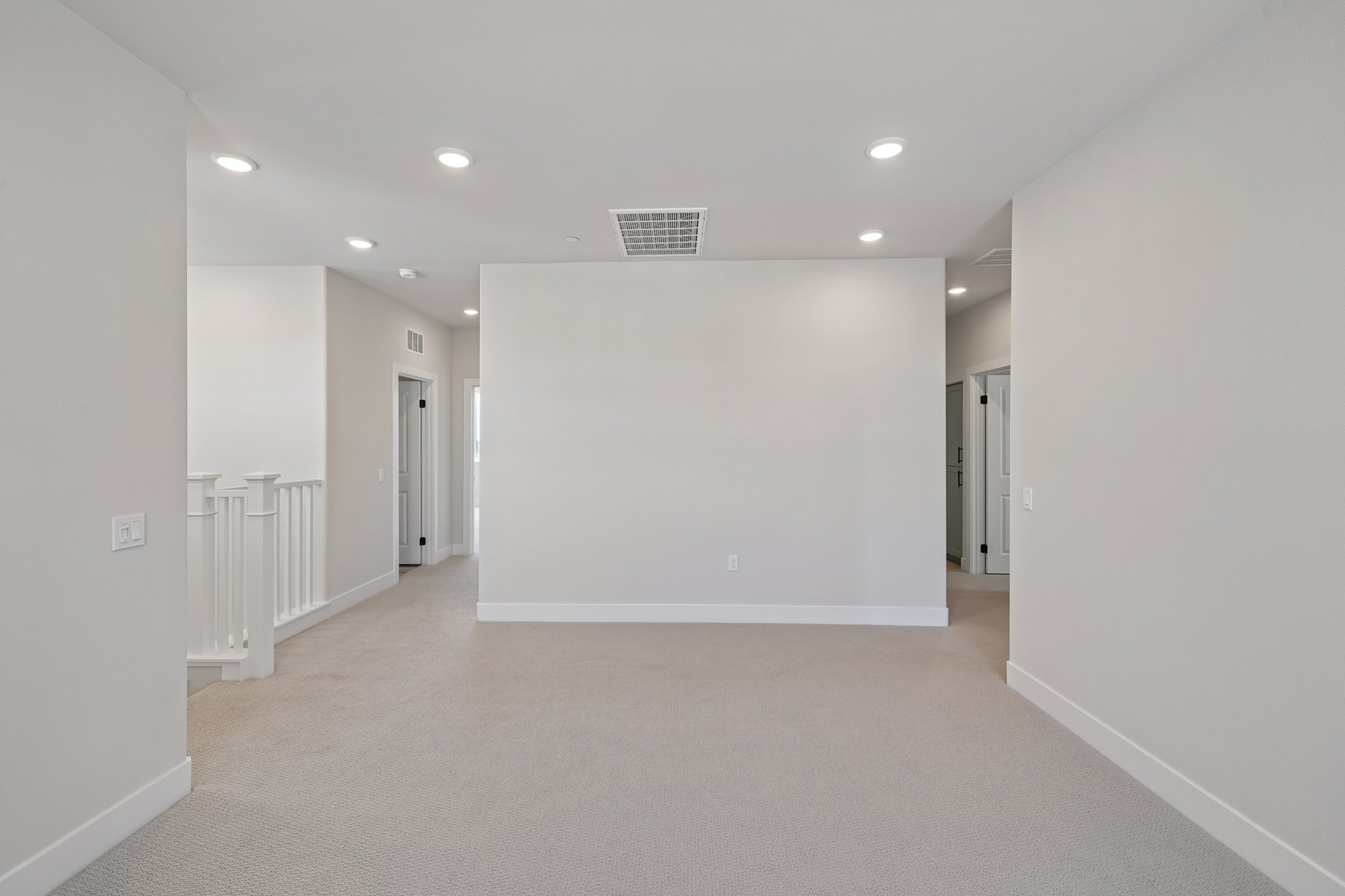 A long hallway with white walls.
