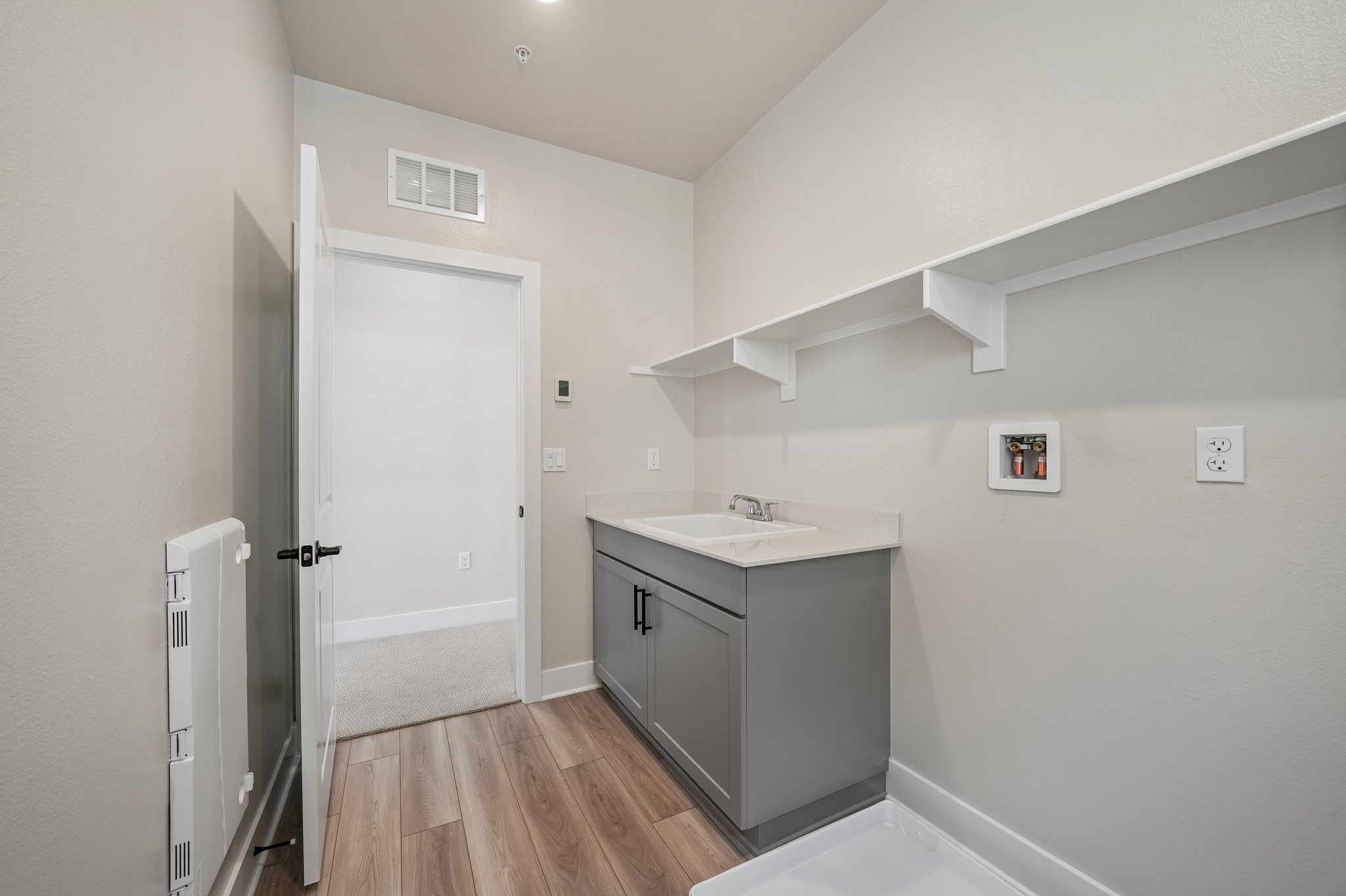 A bathroom with a sink and cabinets.