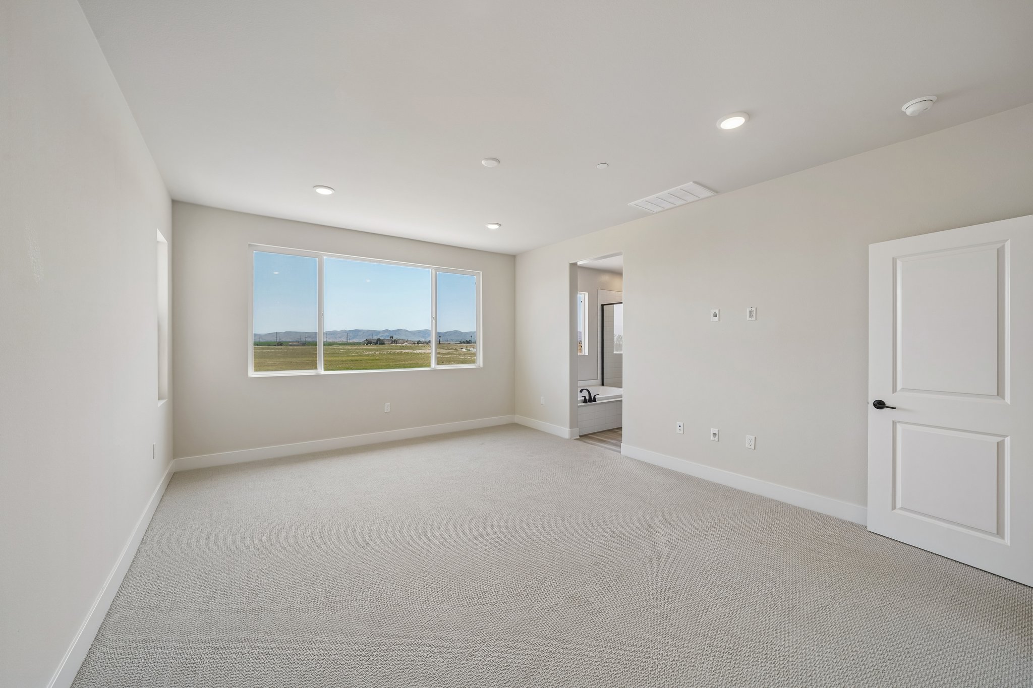 A room with a window and a door.