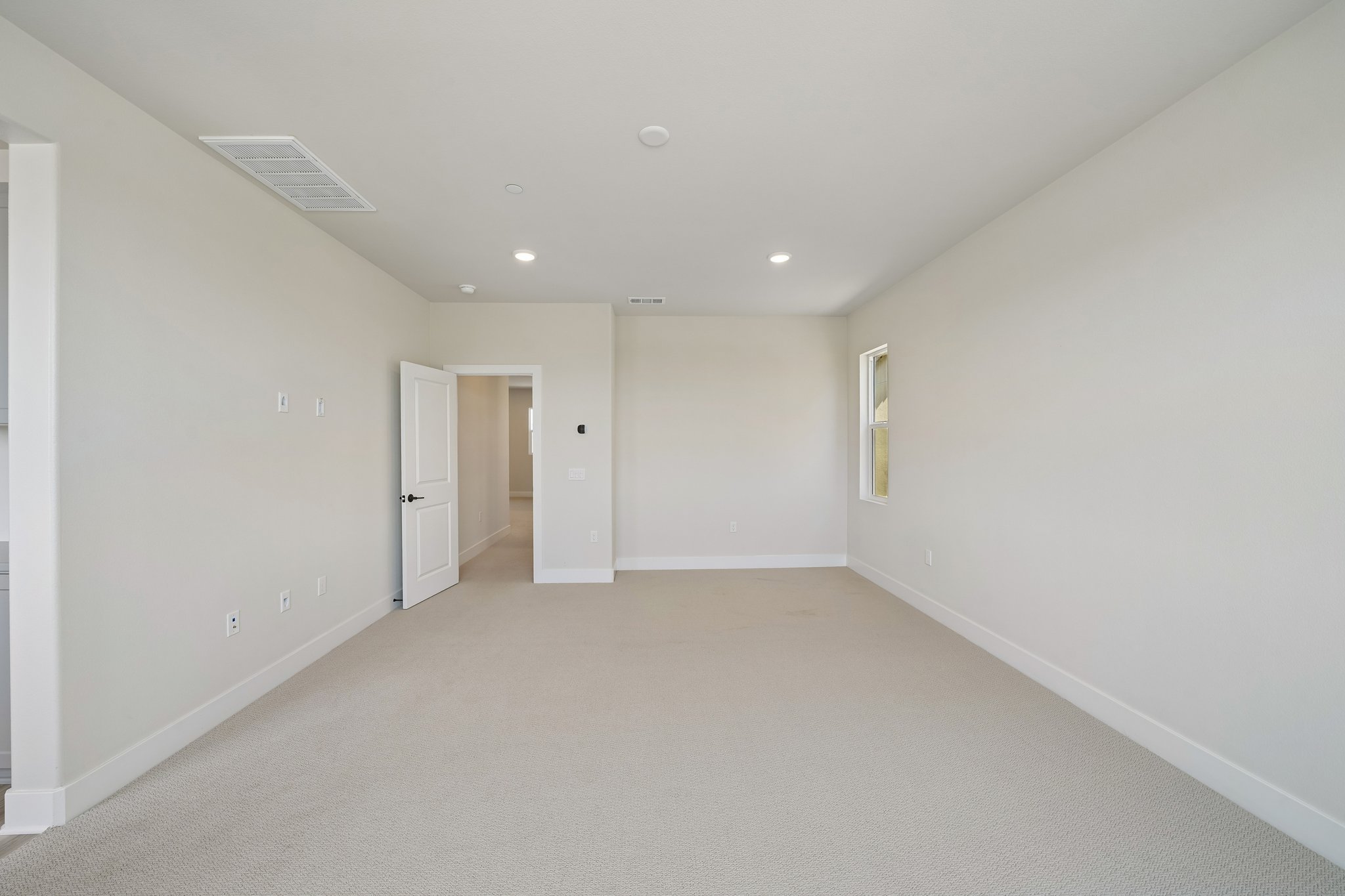 A hallway with white walls.