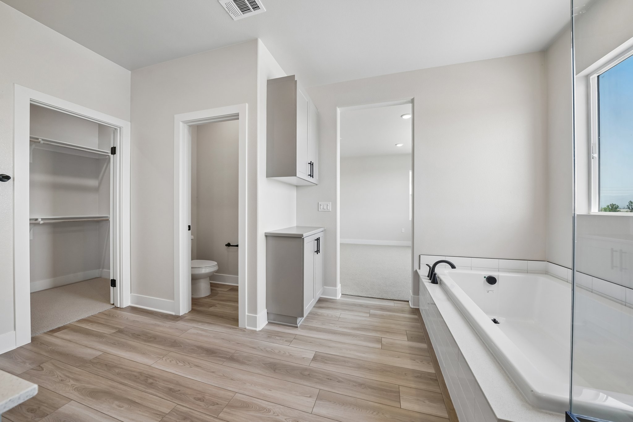 A bathroom with a tub toilet and sink.