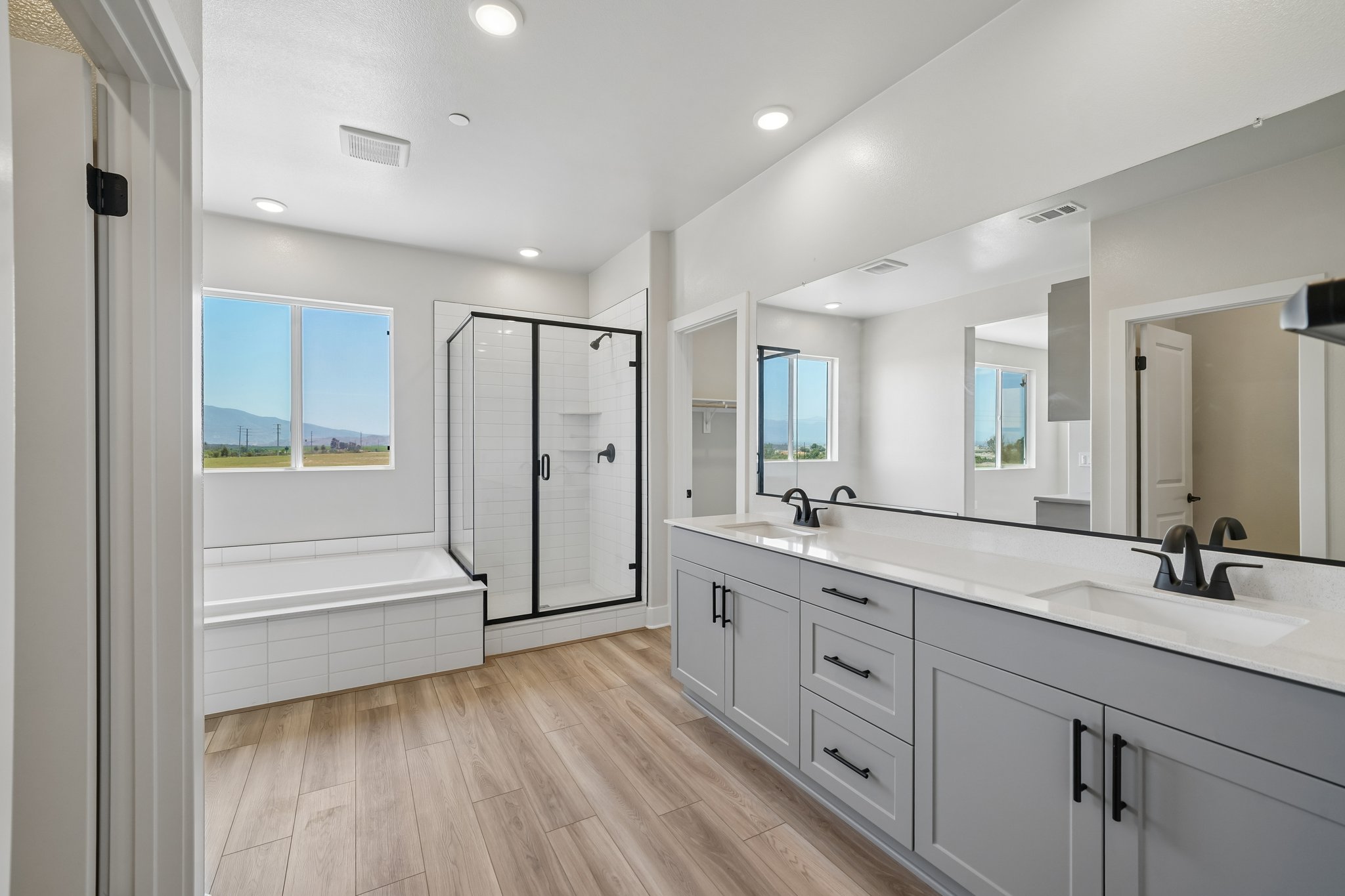 A bathroom with white cabinets.