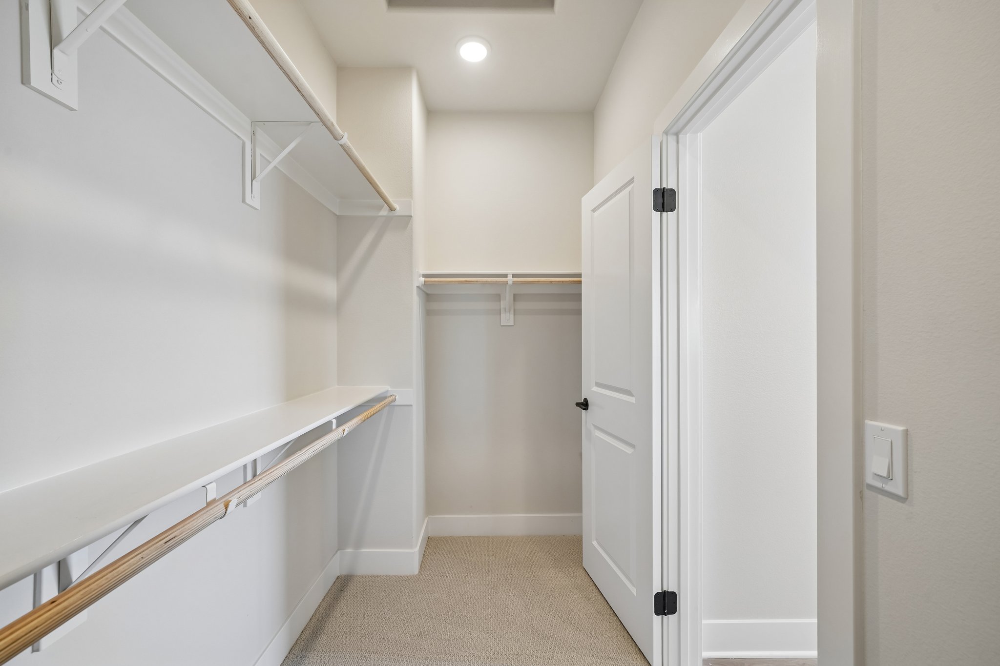 A hallway with white doors.