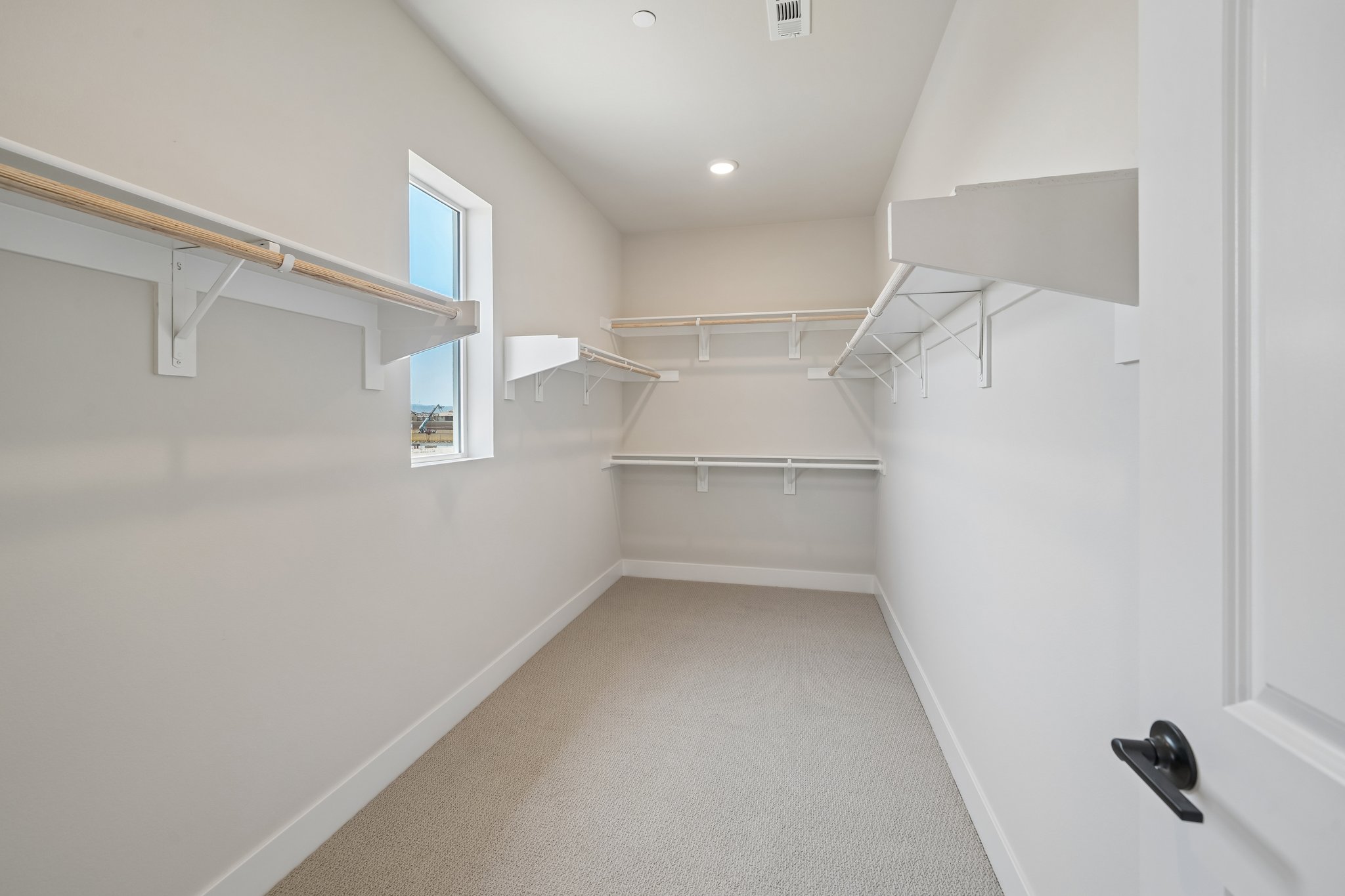 A white hallway with a white wall.