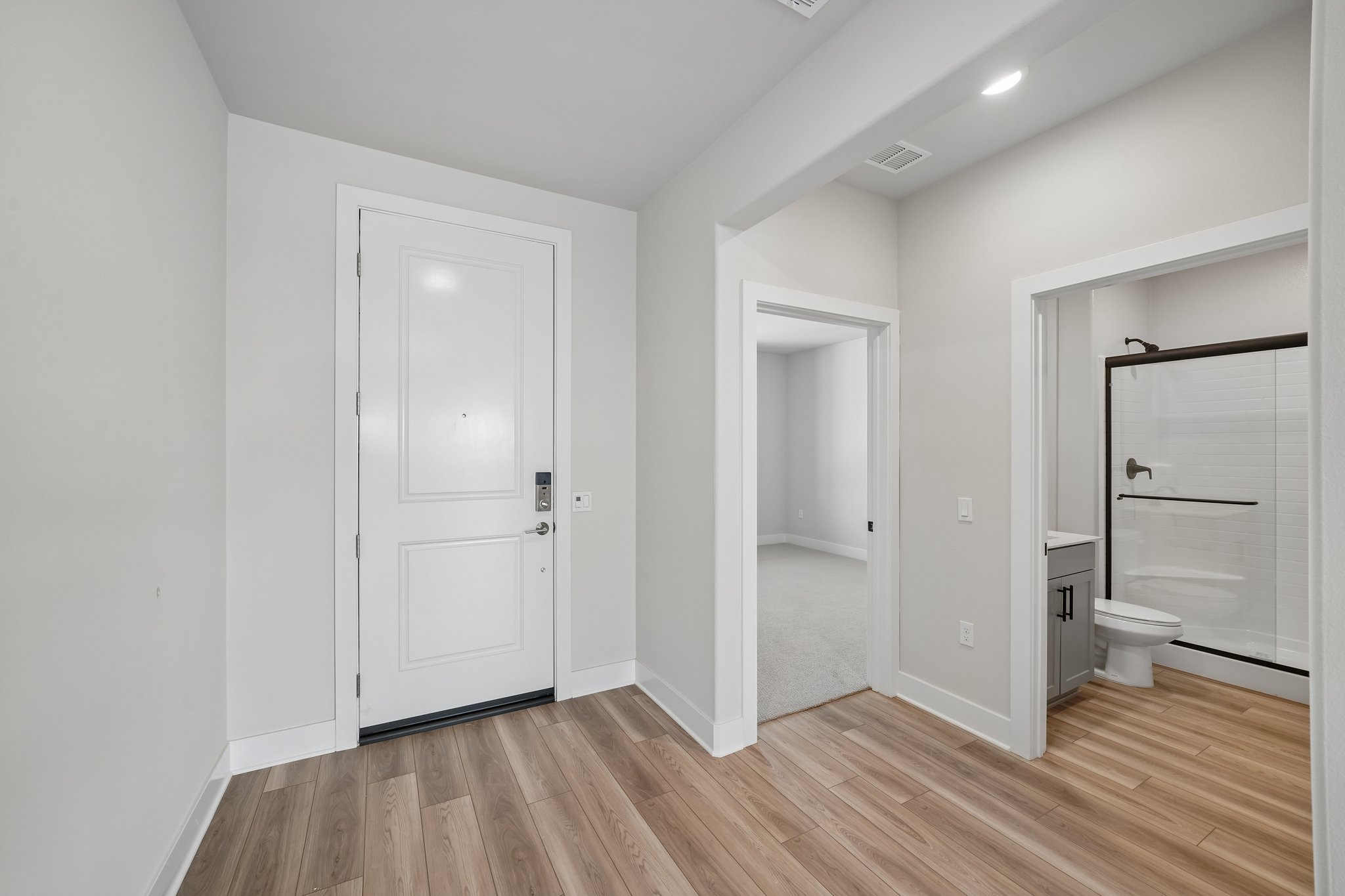 A bathroom with white walls.