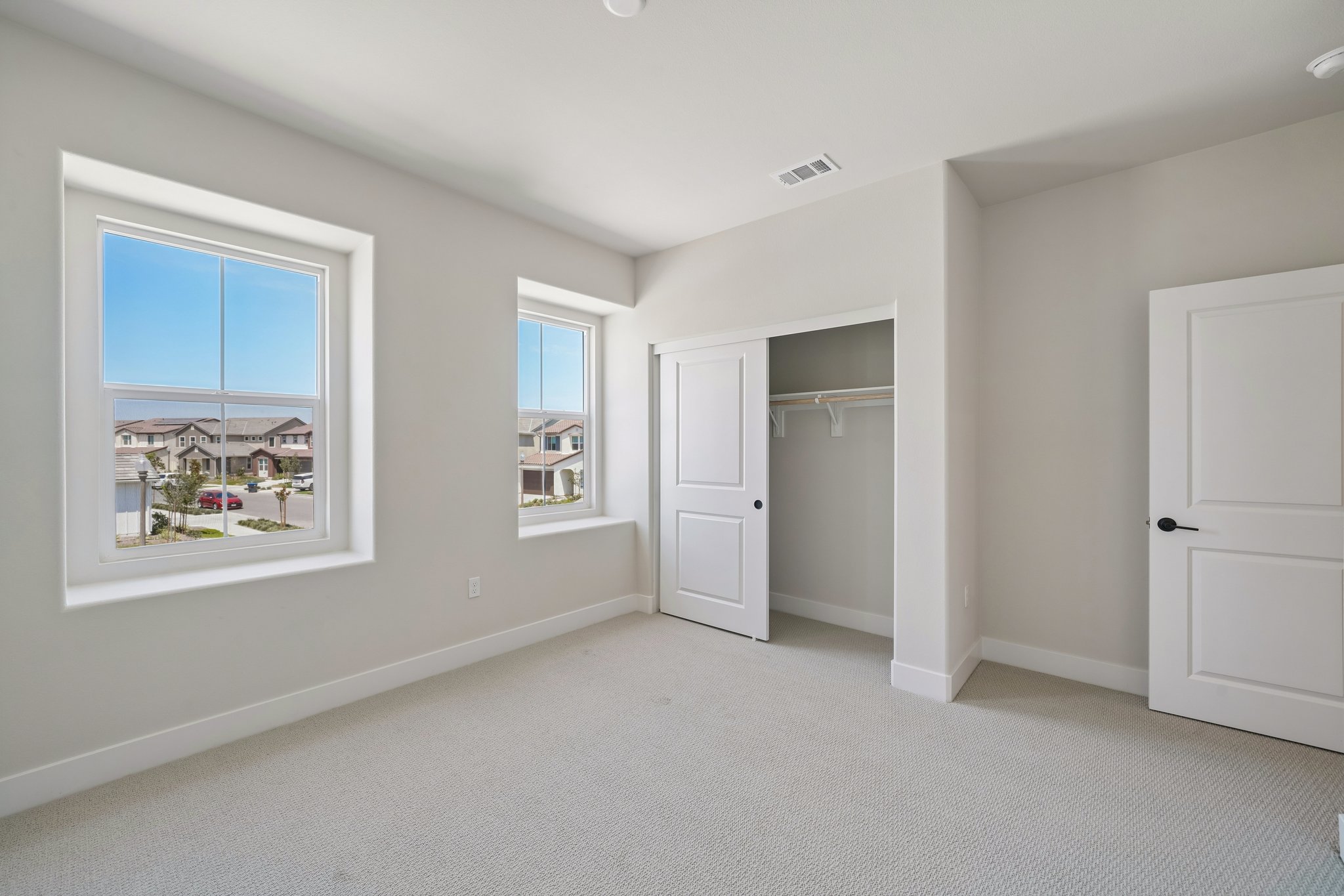 A room with white walls and a window.