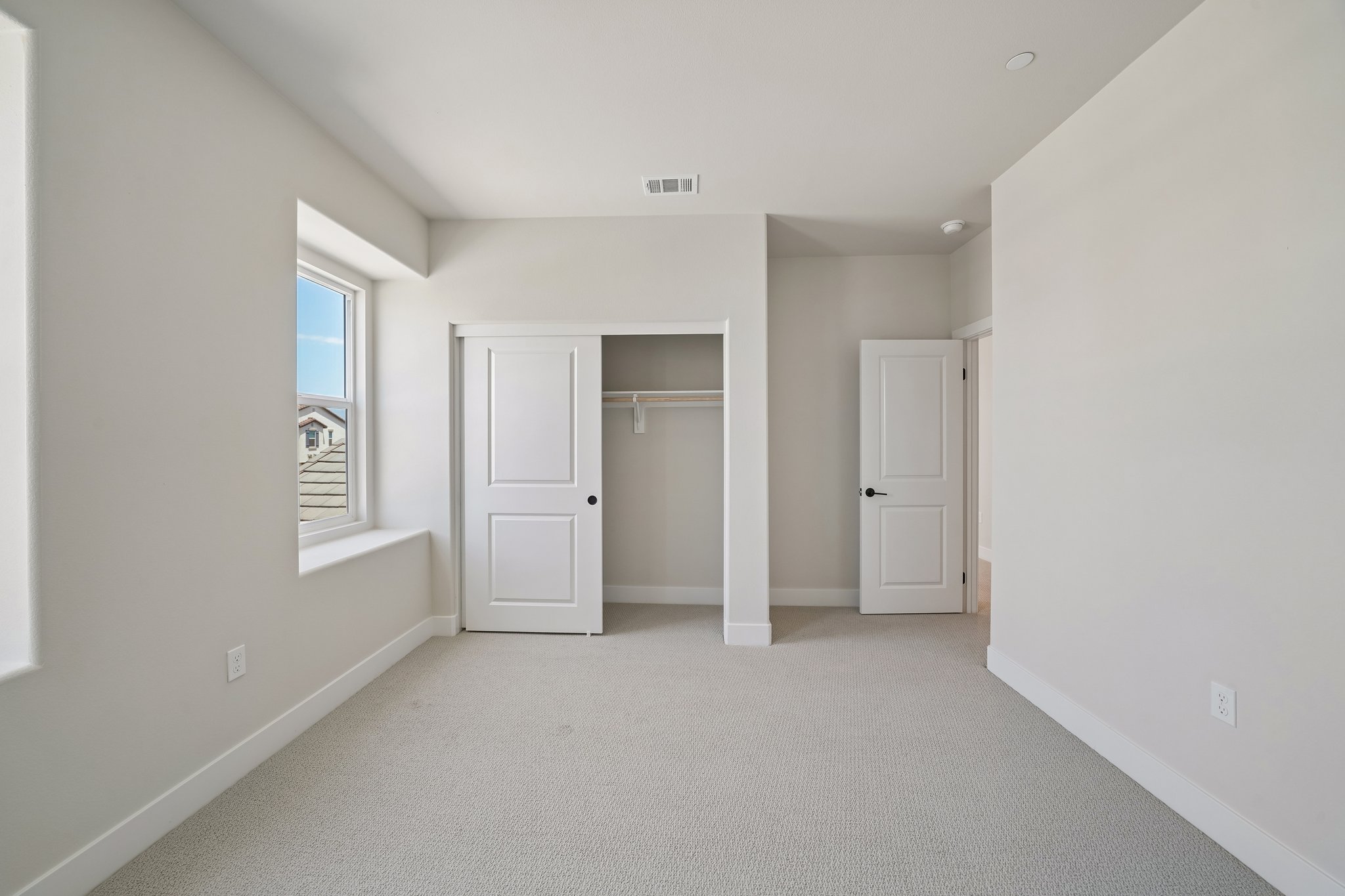 A hallway with white doors.