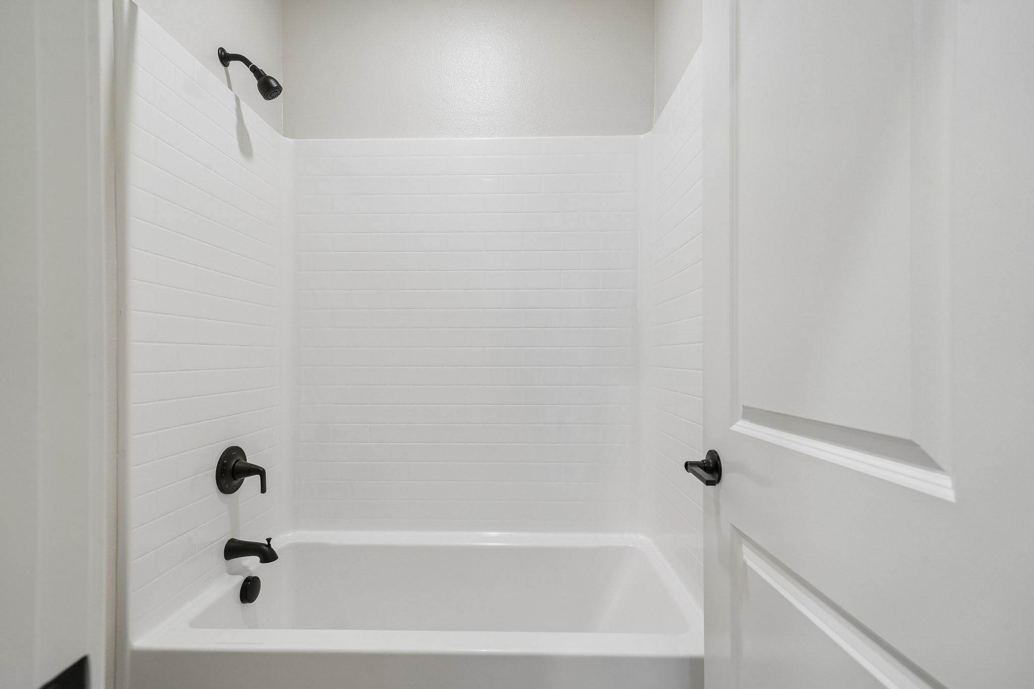 A bathtub in a bathroom.