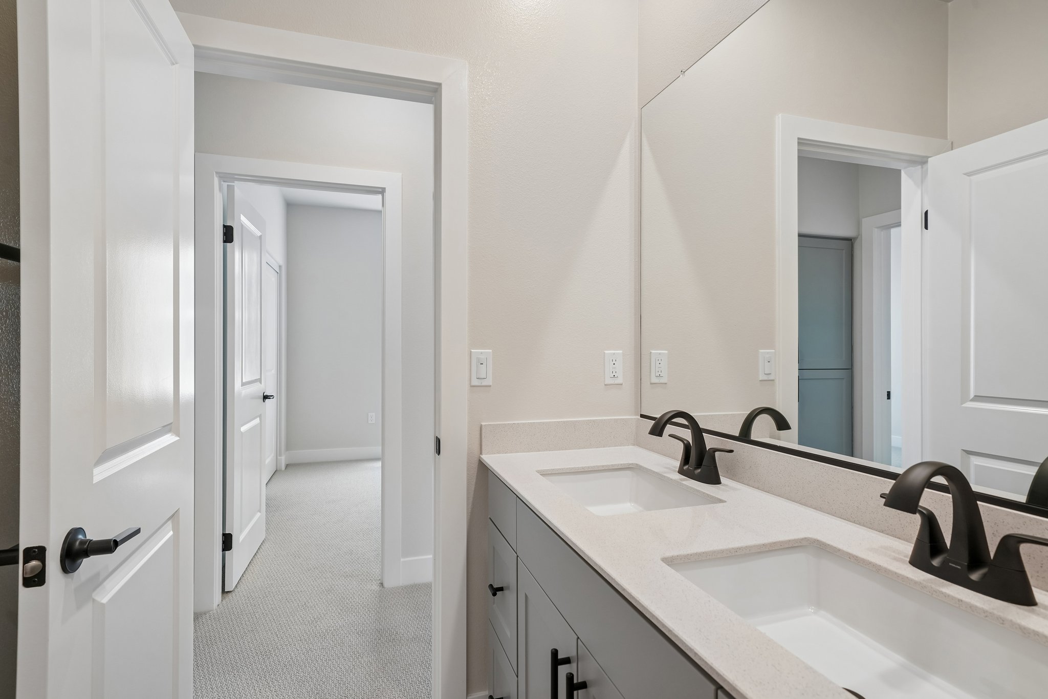 A bathroom with sinks and mirrors.