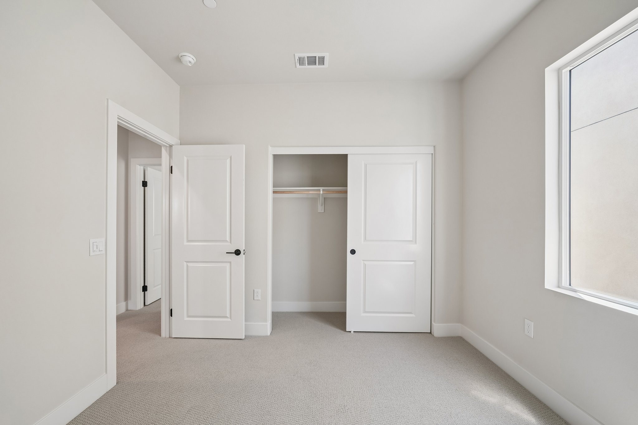 A hallway with white doors.