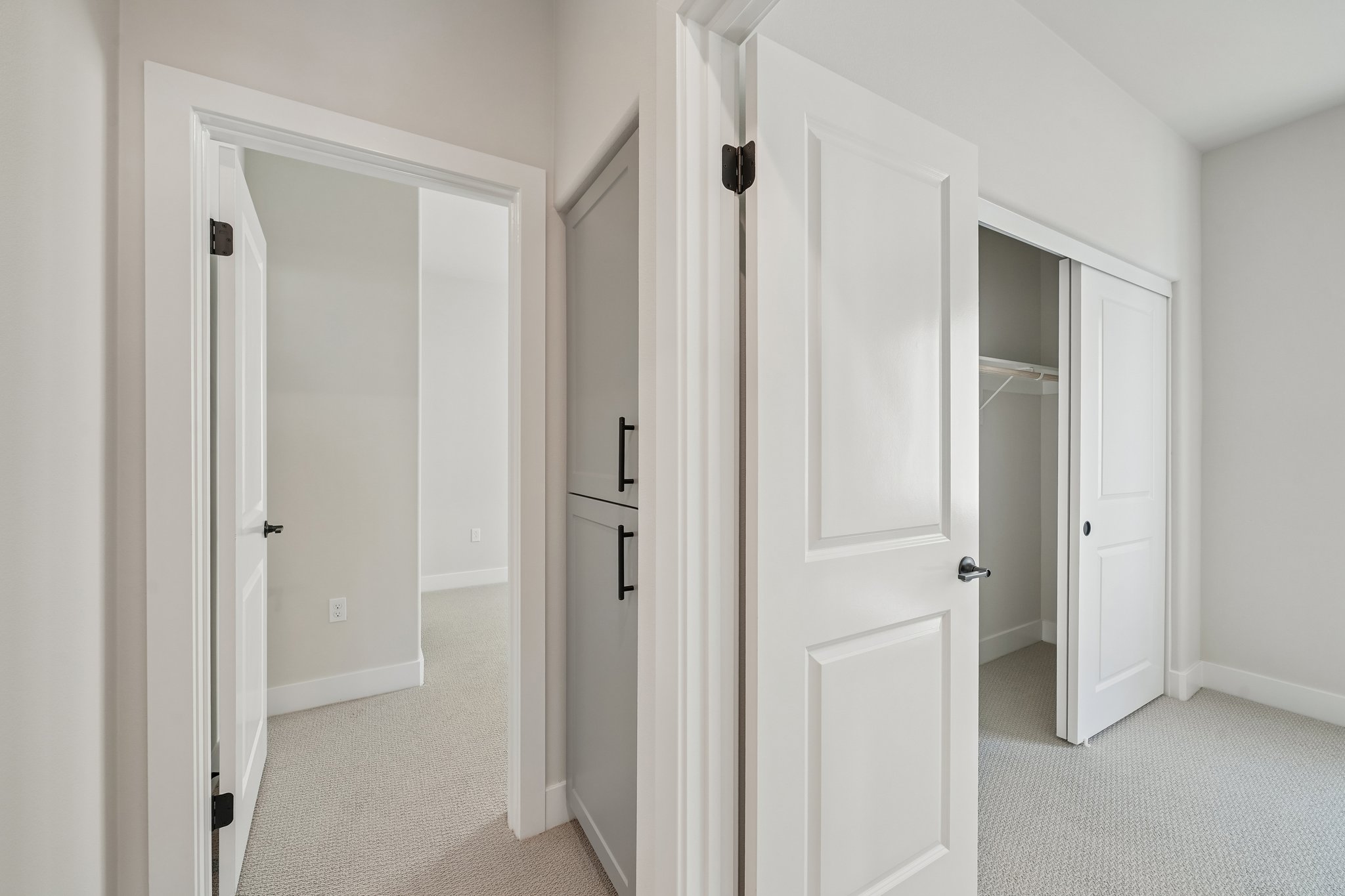 A hallway with white doors.