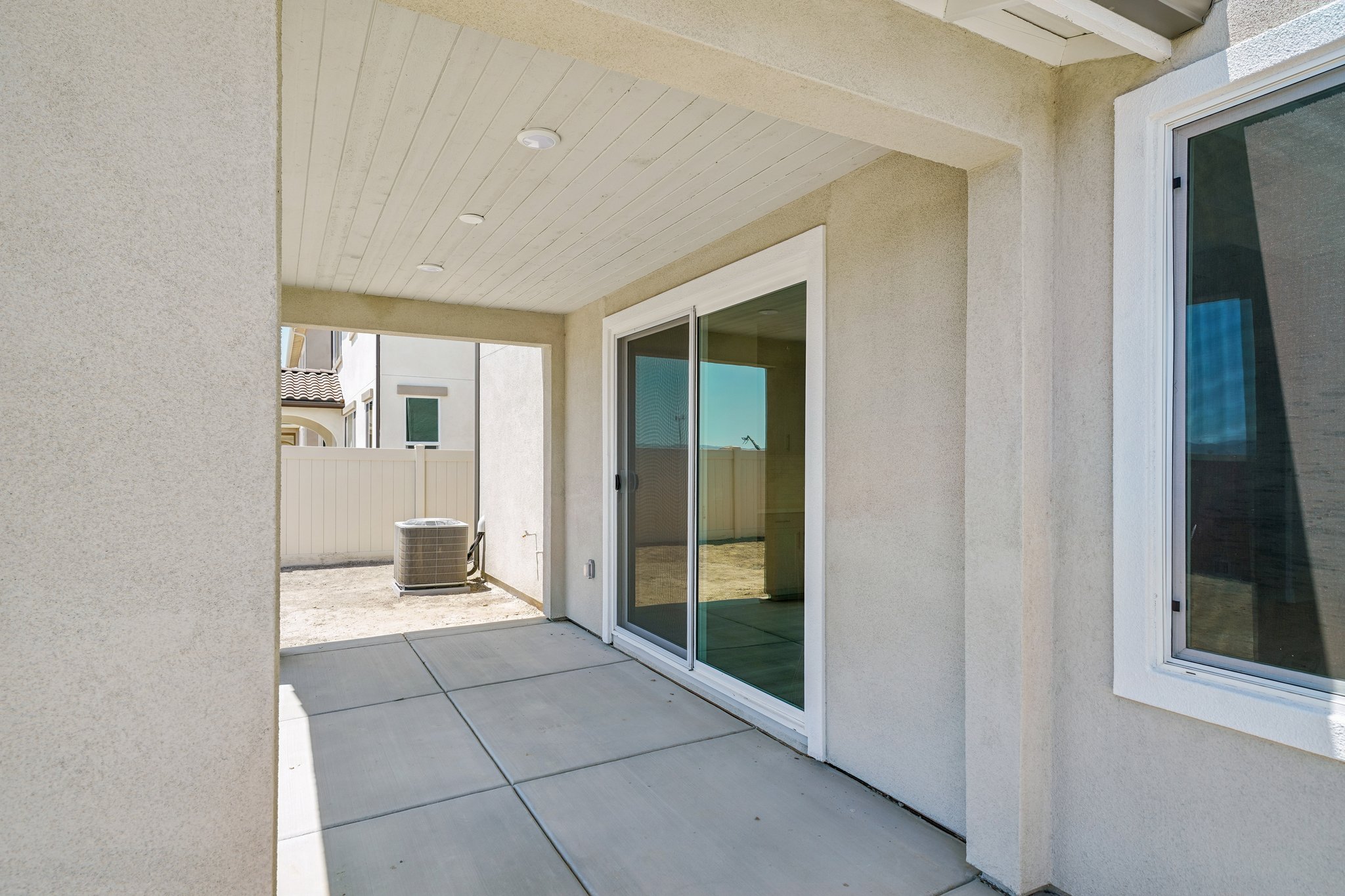 A hallway with a glass door.