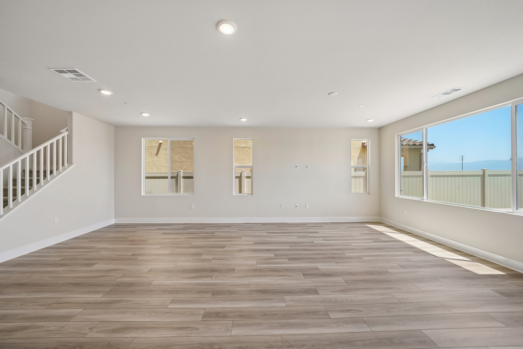 A room with a wood floor and white walls.