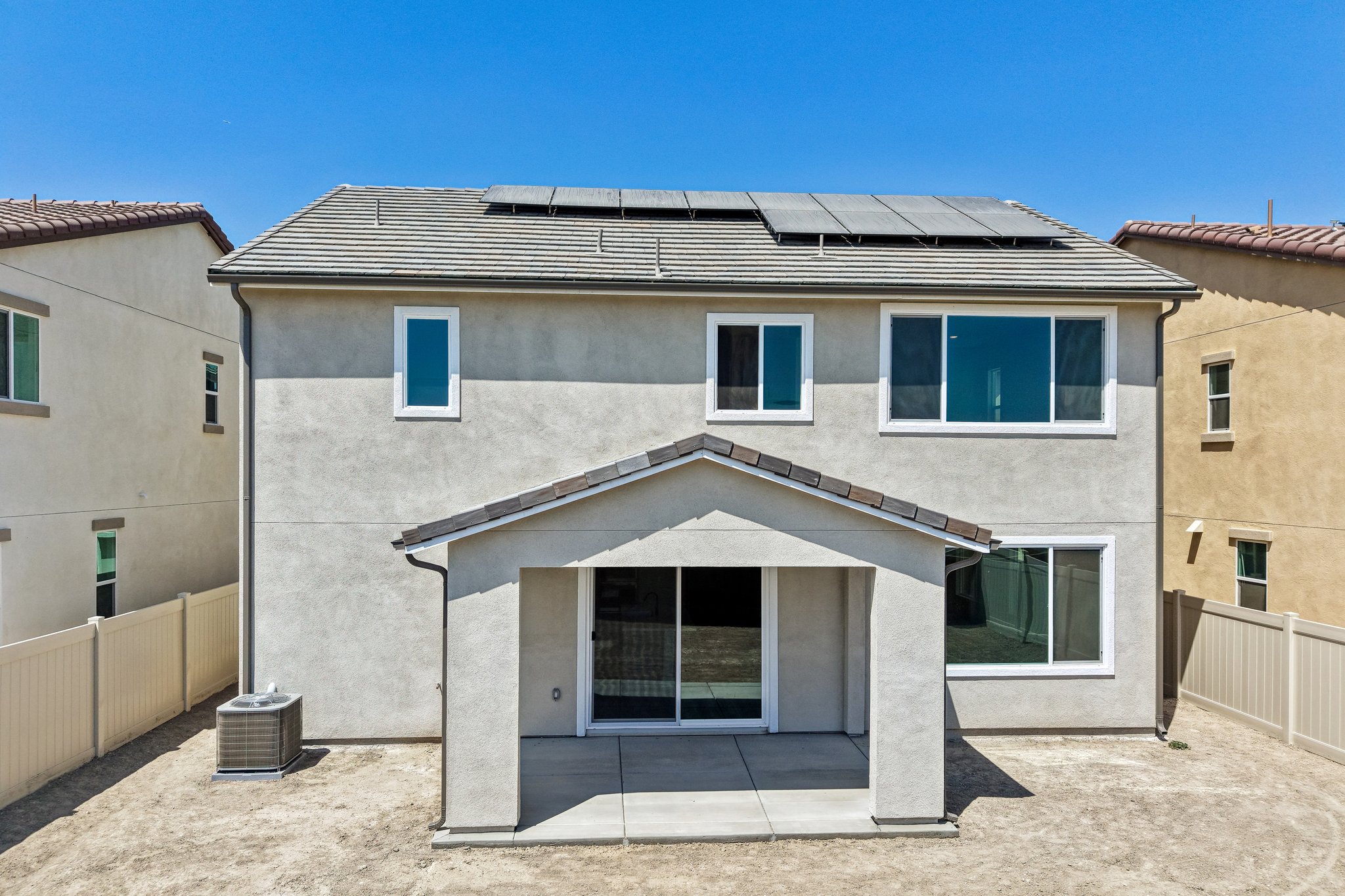A grey house with a garage.