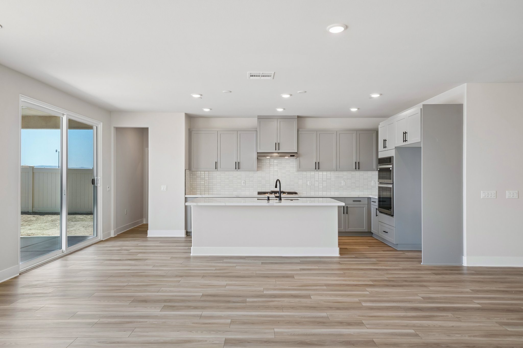 A kitchen with white cabinets.