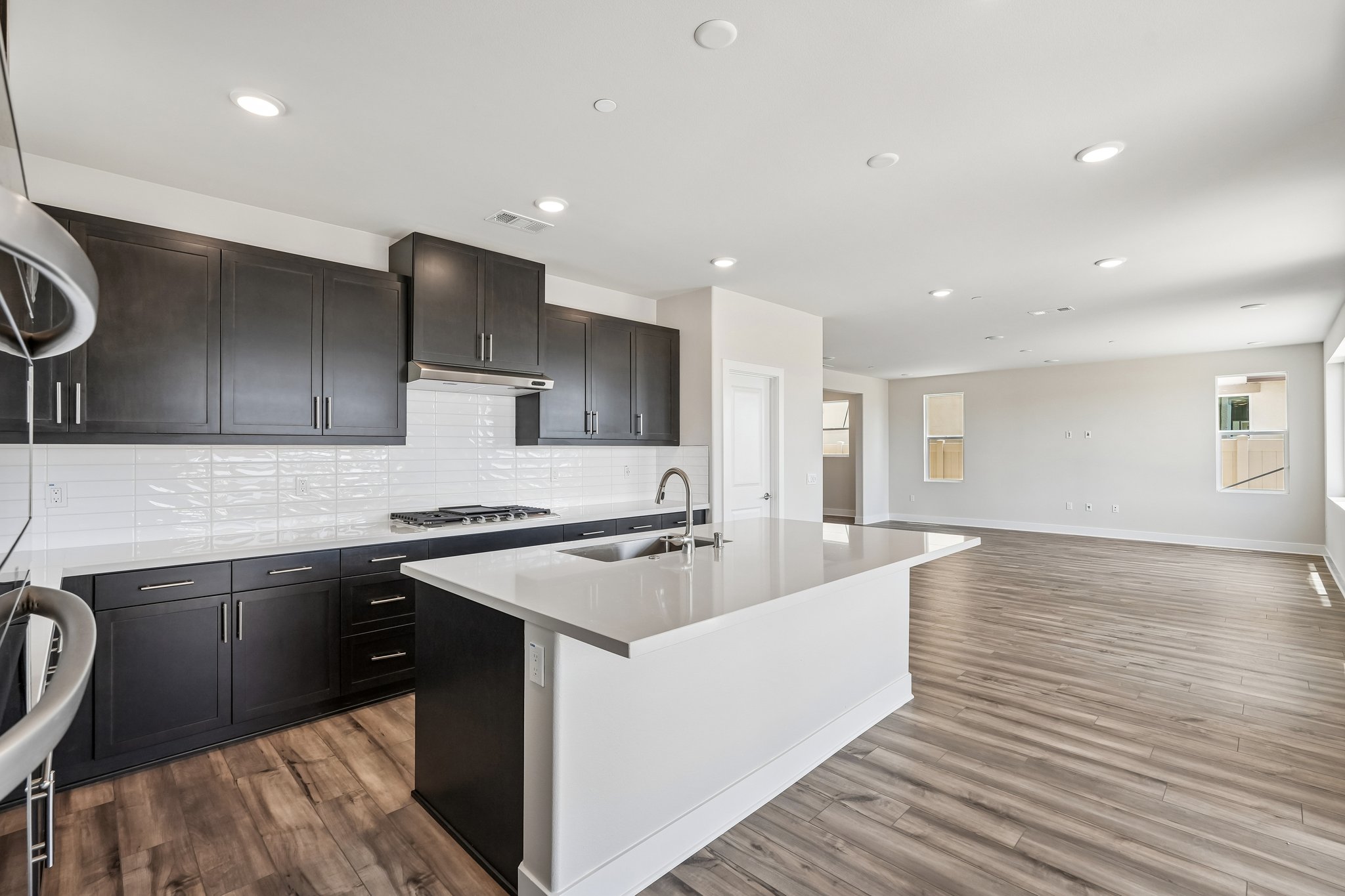A kitchen with black cabinets.
