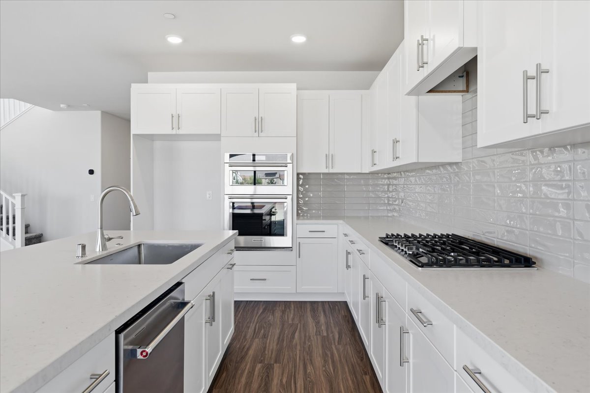 A kitchen with white cabinets.