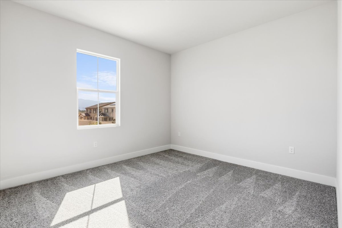 A room with a window and a tile floor.