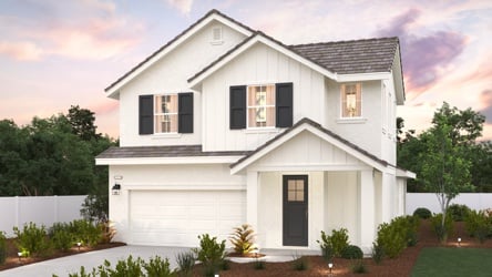 A white house with a driveway.