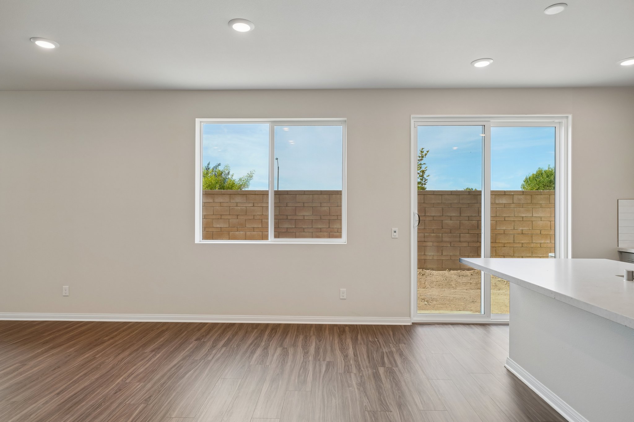 A room with windows and a wood floor.