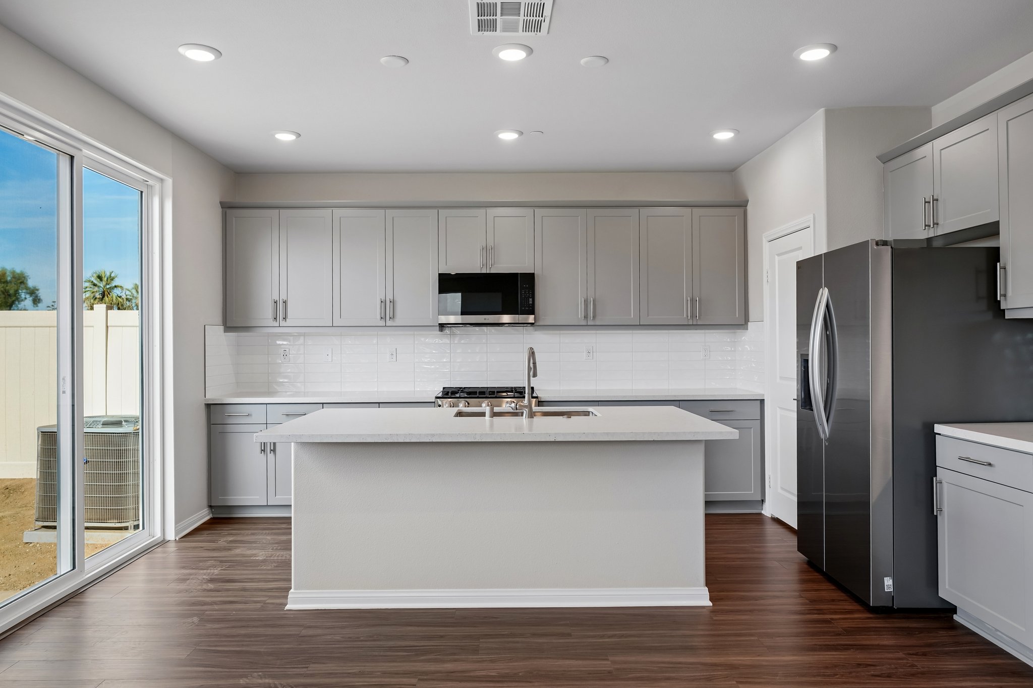 A kitchen with white cabinets.