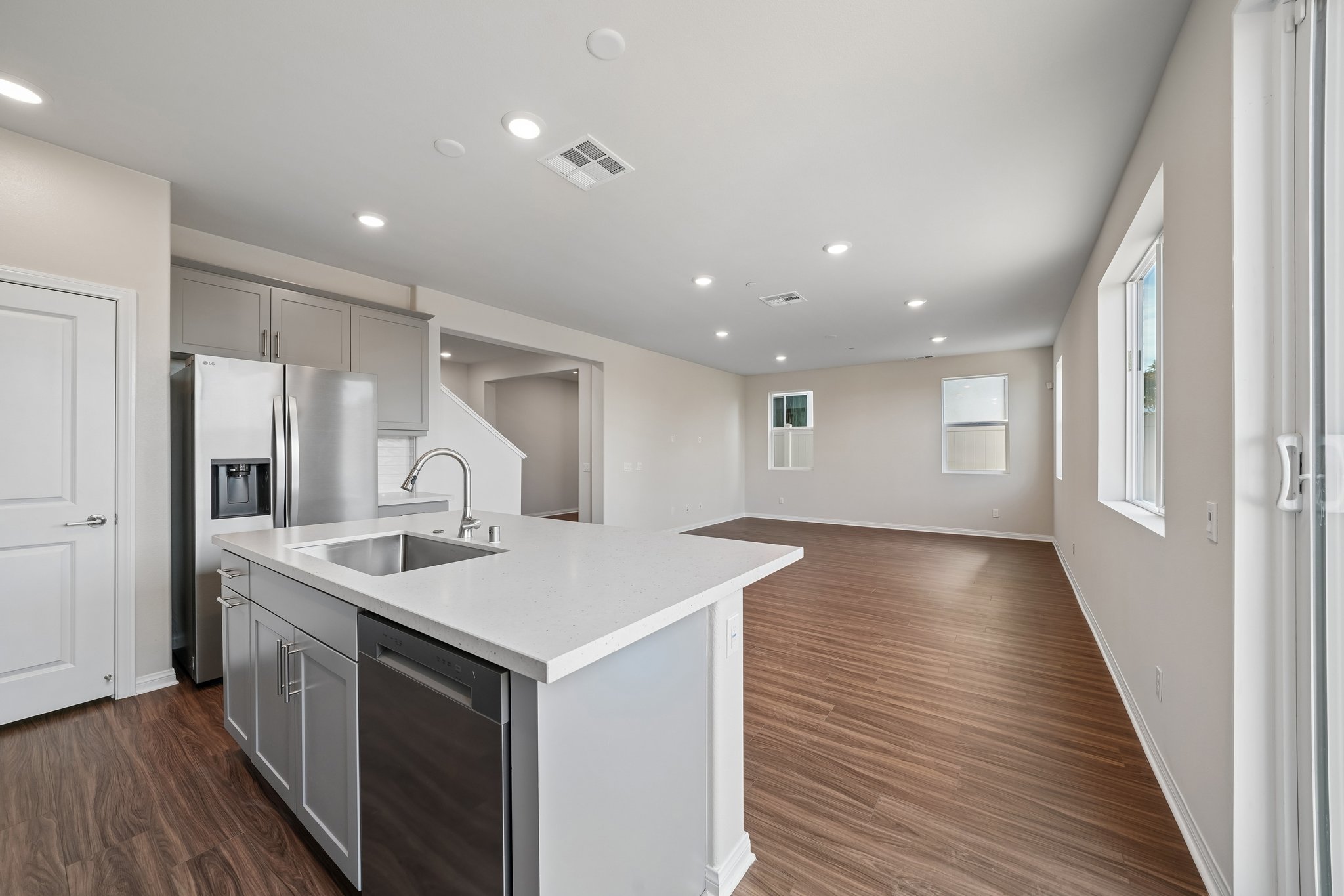 A kitchen with white cabinets.