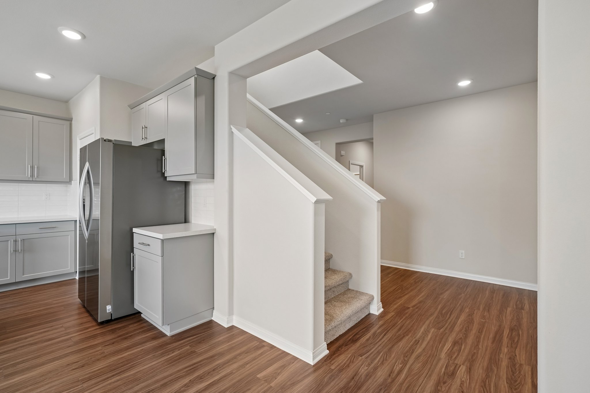 A kitchen with white cabinets.