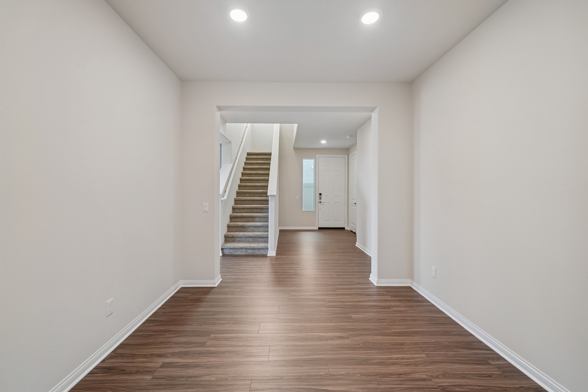 A hallway with white walls.